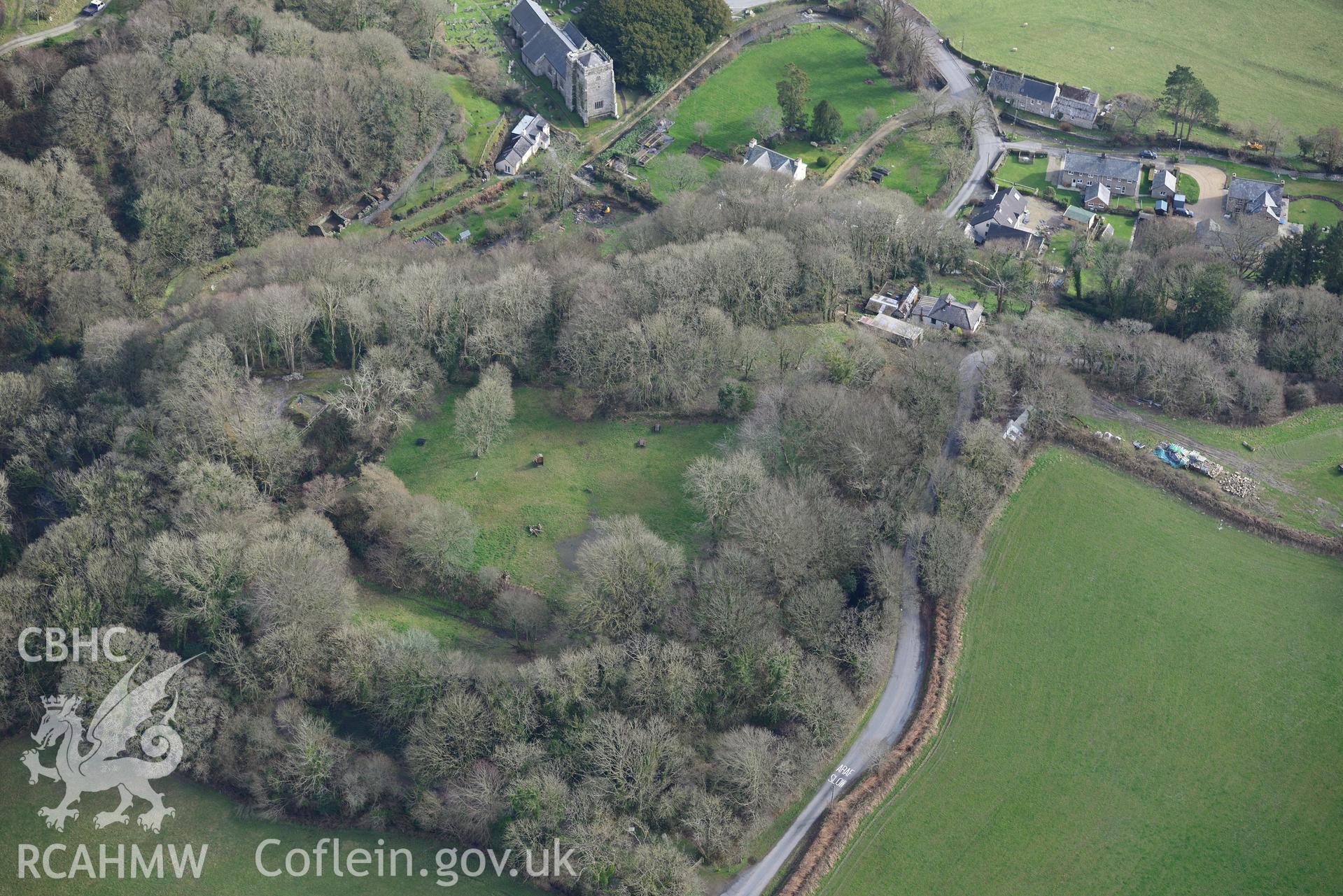 Nevern Castle and St. Brynach's church in the village of Nevern. Oblique aerial photograph taken during the Royal Commission's programme of archaeological aerial reconnaissance by Toby Driver on 13th March 2015.