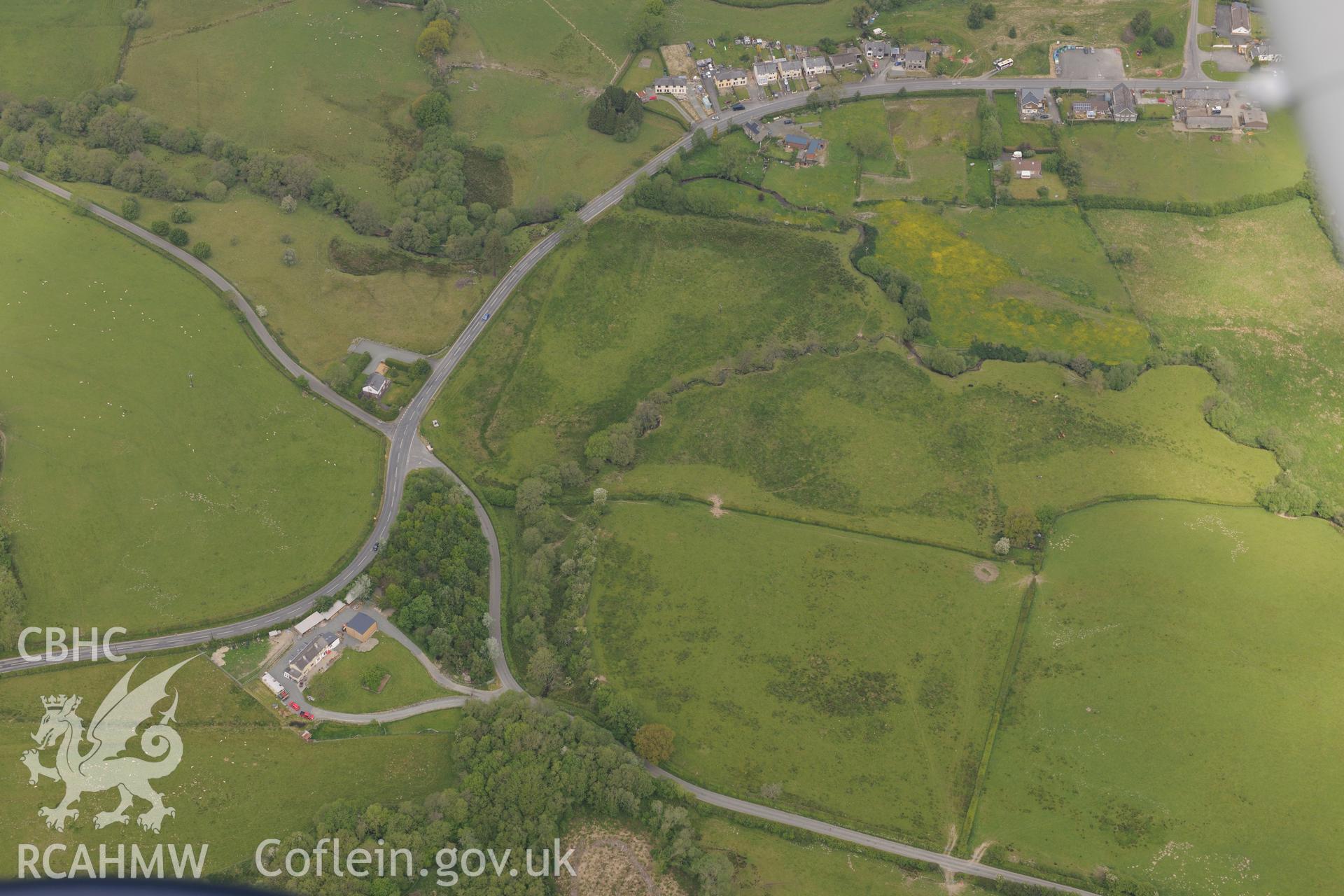 Barrow II on the Hundred House Common, Hundred House Fulling Mill and Catwlws farmhouse. Oblique aerial photograph taken during the Royal Commission's programme of archaeological aerial reconnaissance by Toby Driver on 11th June 2015.