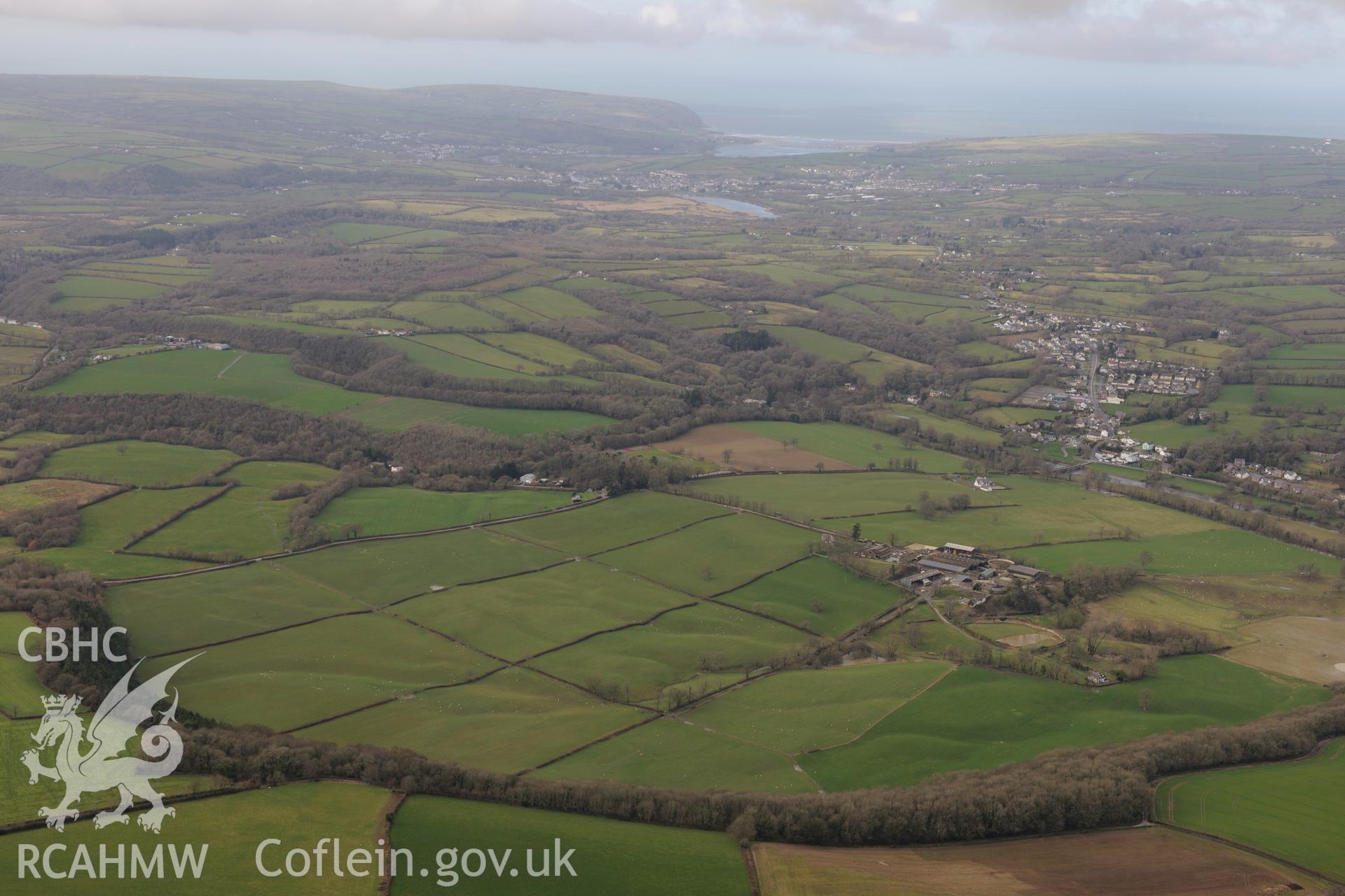 Long view of Castle Malgwyn Model Farm and the village of Llechryd beyond, near Cardigan. Oblique aerial photograph taken during the Royal Commission's programme of archaeological aerial reconnaissance by Toby Driver on 13th March 2015.