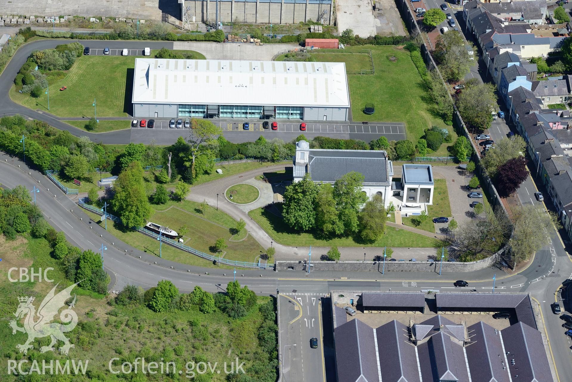 Pembroke dockyard and the market hall, Pembroke Dock. Oblique aerial photograph taken during the Royal Commission's programme of archaeological aerial reconnaissance by Toby Driver on 13th May 2015.