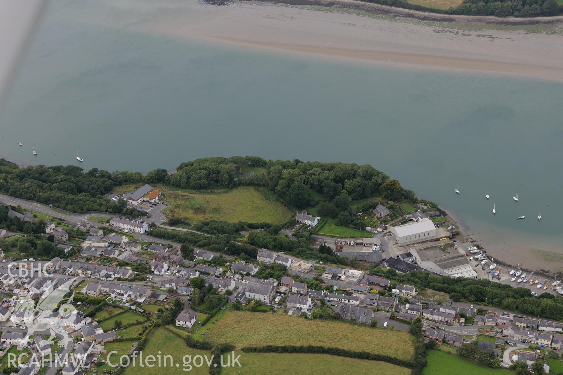 Dinas Camp iron age promontory fort, and the shipbuilding yard at Y Felinheli. Oblique aerial photograph taken during the Royal Commission's programme of archaeological aerial reconnaissance by Toby Driver on 11th September 2015.