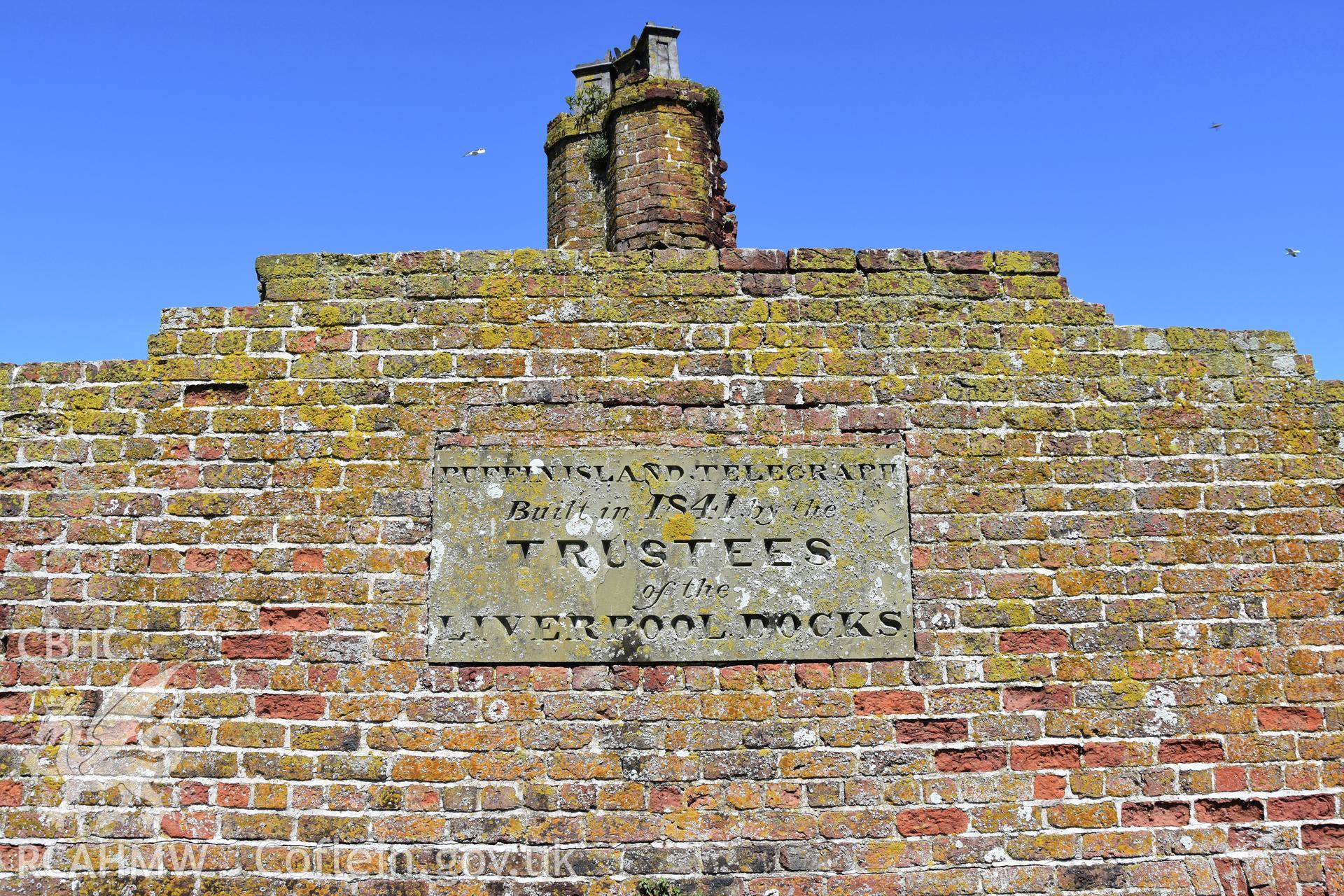 Investigator's photographic survey of the Telegraph Station on Puffin Island or Ynys Seiriol for the CHERISH Project. View of external stone plaque on south side of station erected by Trustees of Liverpool Docks. ? Crown: CHERISH PROJECT 2018. Produced with EU funds through the Ireland Wales Co-operation Programme 2014-2020. All material made freely available through the Open Government Licence.