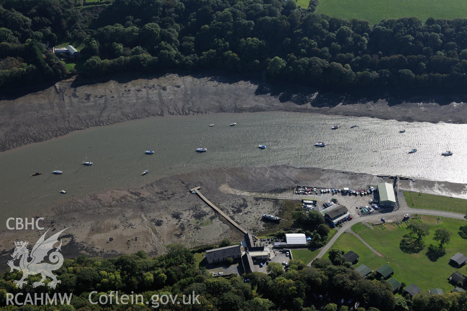 Lawrenny village, its quay & site of the ferry seaplane base on the banks of the Daugleddau river, near Pembroke Dock. Oblique aerial photograph taken during Royal Commission?s programme of archaeological aerial reconnaissance by Toby Driver on 30/9/2015.