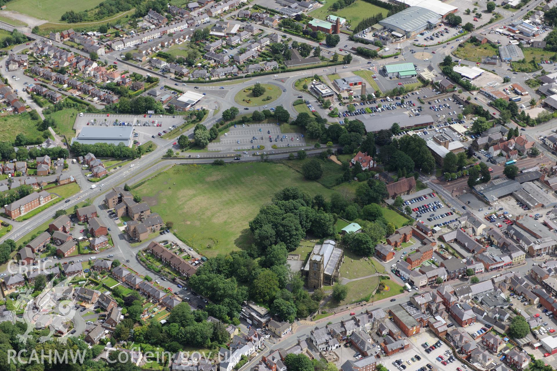 St. John's Welsh Church, St. Mary's Church and St David's Catholic Church, Mold. Oblique aerial photograph taken during the Royal Commission's programme of archaeological aerial reconnaissance by Toby Driver on 30th July 2015.