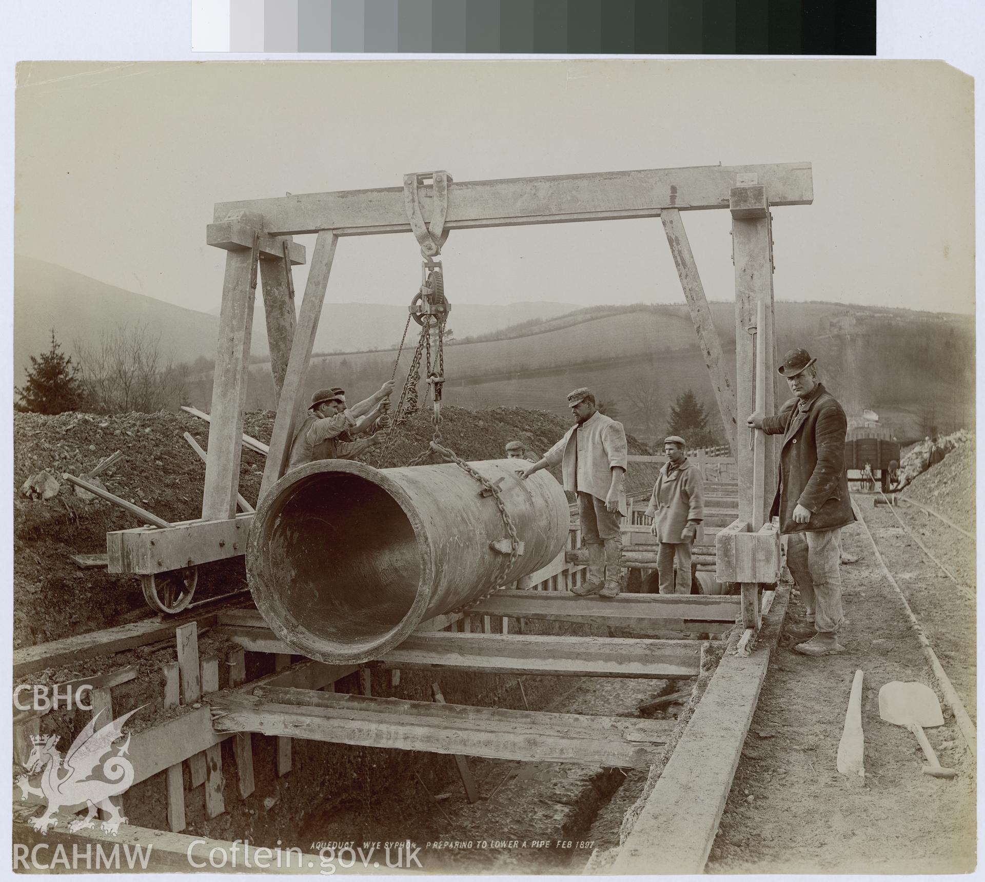 Digital copy of an albumen print from Edward Hubbard Collection showing aqueduct at Wye Syphon with men preparing to lower pipe, taken February 1887.