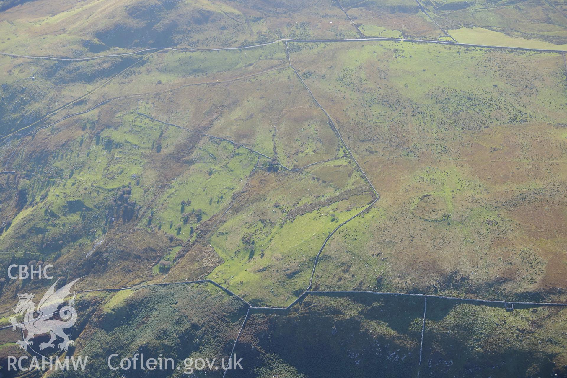 An enclosure at Morfa and hut circles south east of Mynydd Craig Wen, near Fairbourne. Oblique aerial photograph taken during the Royal Commission's programme of archaeological aerial reconnaissance by Toby Driver on 2nd October 2015.