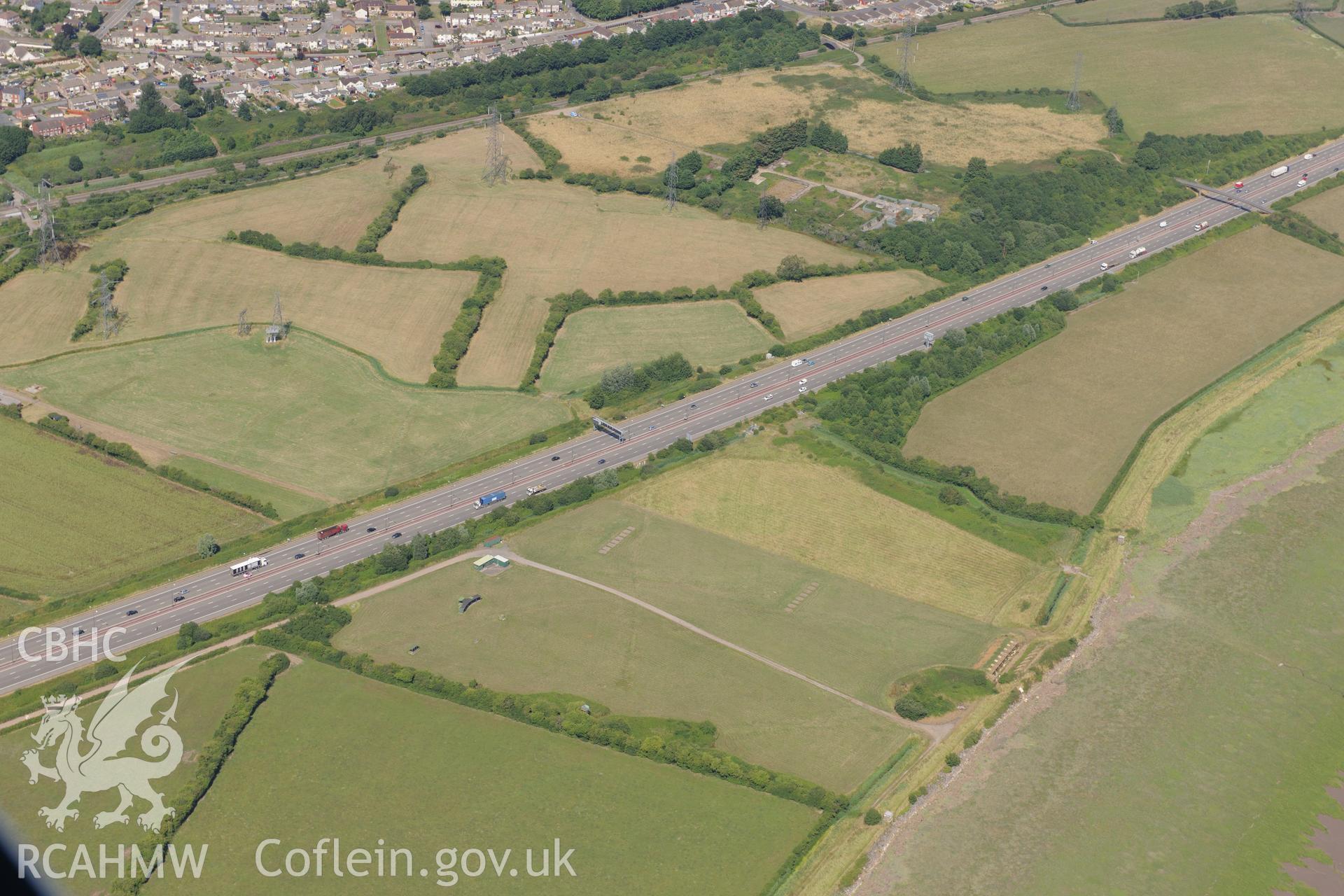 Caldicot level ridge & furrow, rifle range & M4 motorway section passing southern edge of Caldicot on way to 2nd Severn Crossing. Oblique aerial photograph taken during RCAHMW?s programme of archaeological aerial reconnaissance by Toby Driver 01/08/2013.