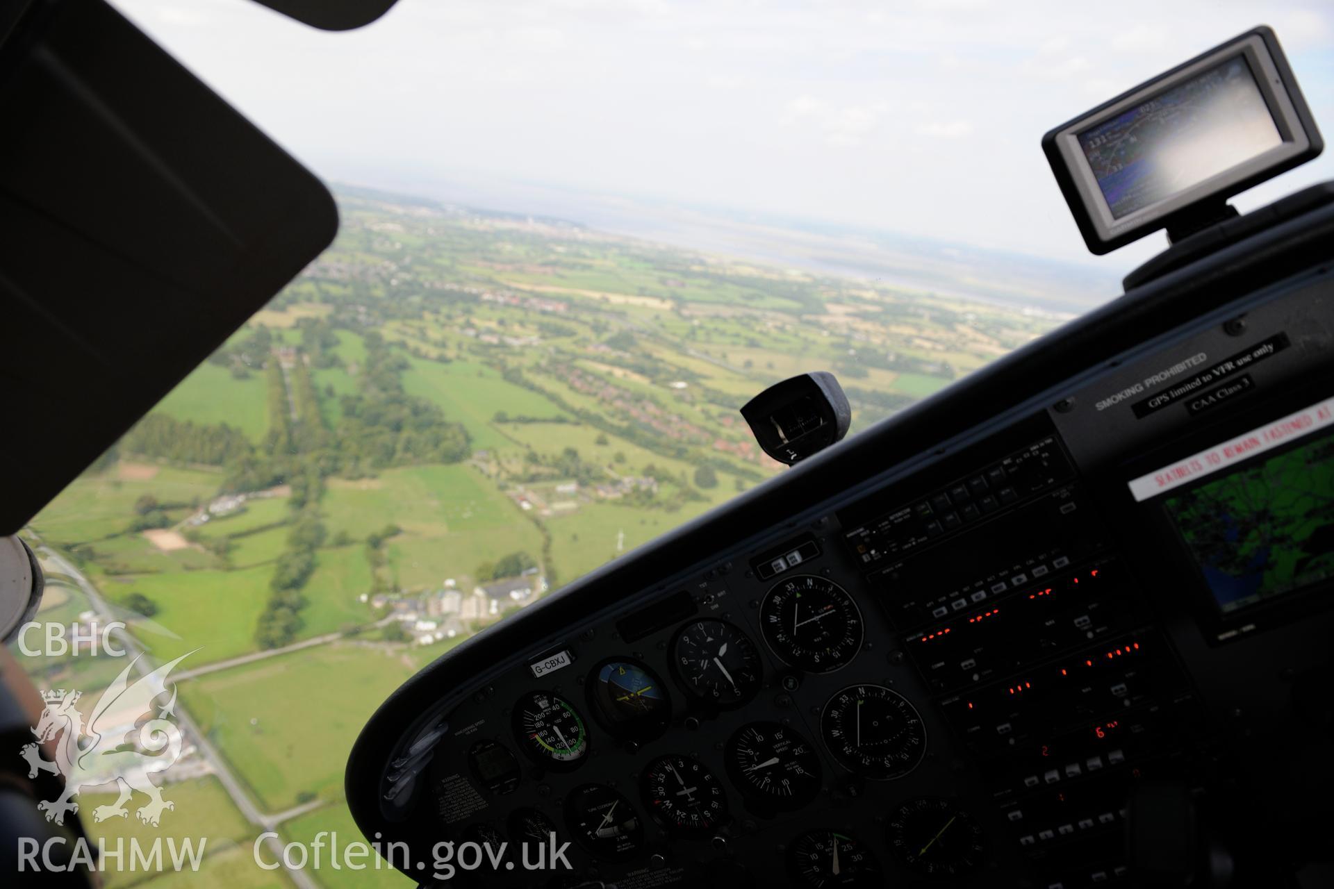 The view from the cockpit between Mold and Connah's Quay. Oblique aerial photograph taken during the Royal Commission's programme of archaeological aerial reconnaissance by Toby Driver on 11th September 2015.