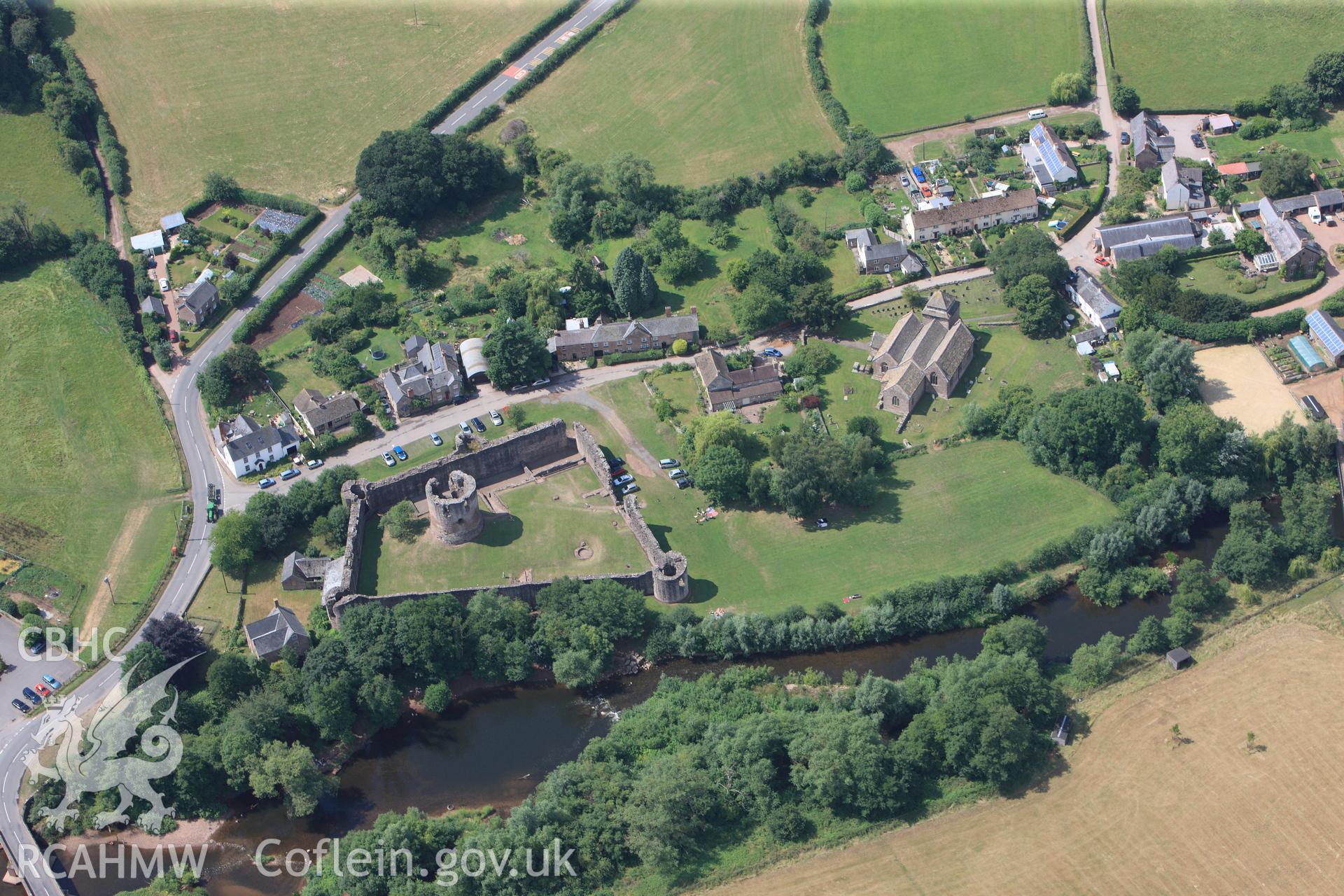 Skenfrith Castle, with Skenfrith corn mill immediately to the south east and St. Bridget's Church to the north west, Skenfrith, Monmouth. Oblique aerial photograph taken during Royal Commission?s programme of archaeological aerial reconnaissance by Toby Driver on 1st August 2013.