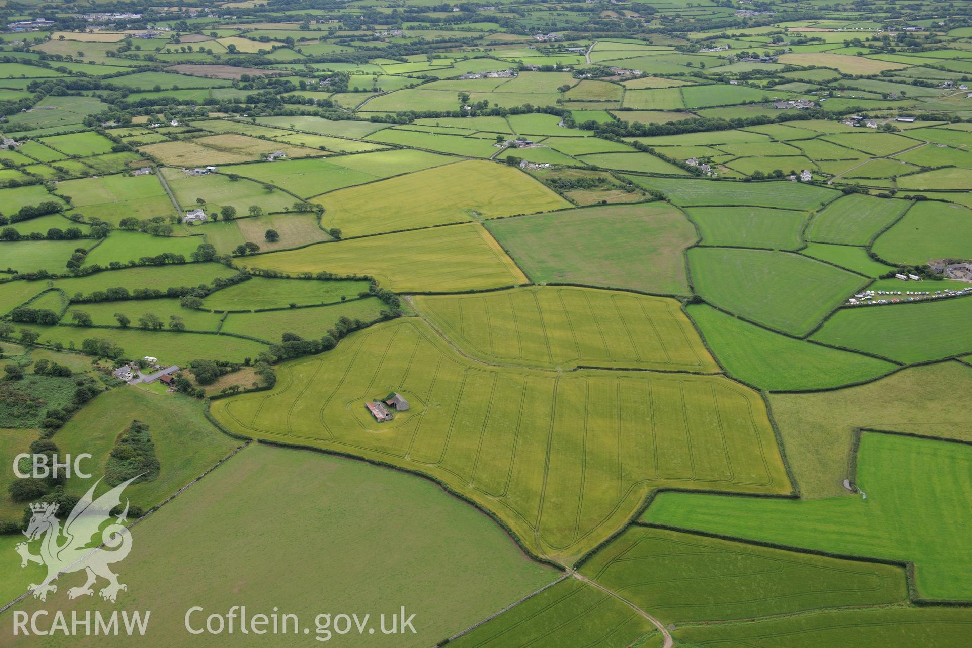 Cropmarks at Rhostryfan and the Llwyn-yn Brickworks. Oblique aerial photograph taken during the Royal Commission's programme of archaeological aerial reconnaissance by Toby Driver on 30th July 2015.