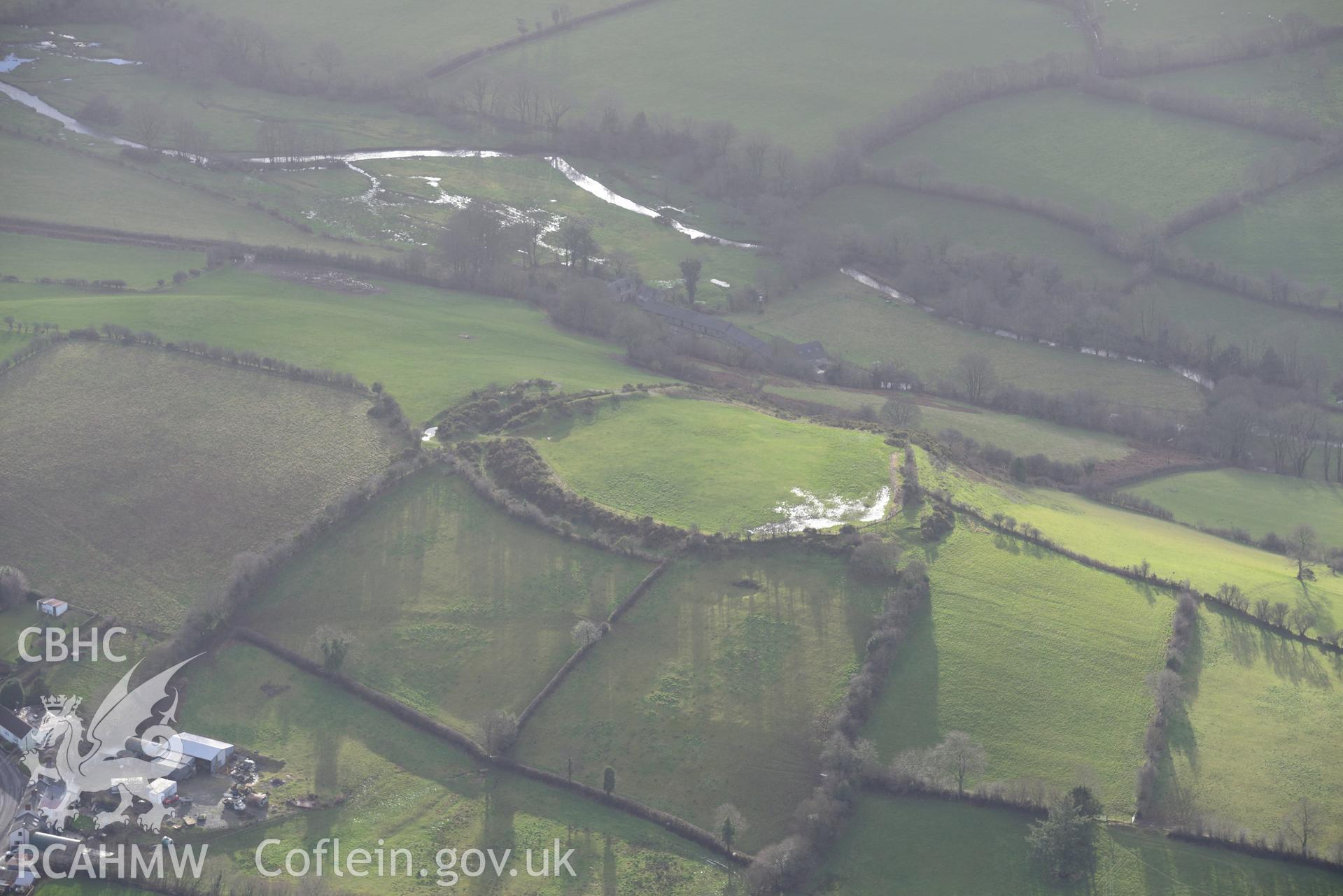 Cribyn village and Gaer Maesmynach hill fort. Oblique aerial photograph taken during the Royal Commission's programme of archaeological aerial reconnaissance by Toby Driver on 6th January 2015.