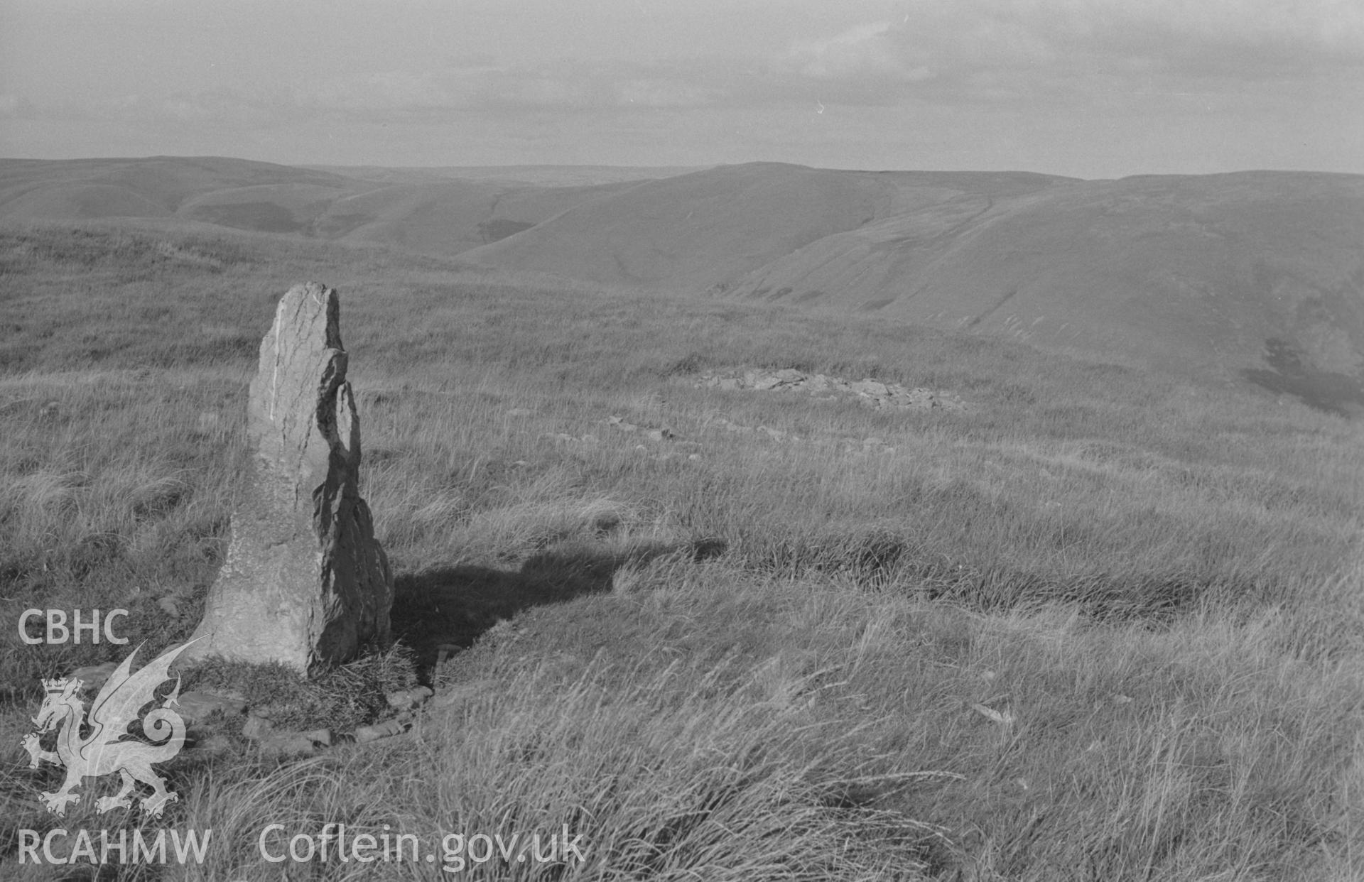 Digital copy of black & white negative showing standing stone and Carnau on Cefn Cnwcheithinog; the Doethie valley in the distance. Photographed by Arthur O. Chater in September 1966 looking north east from Grid Reference SN 757 496.