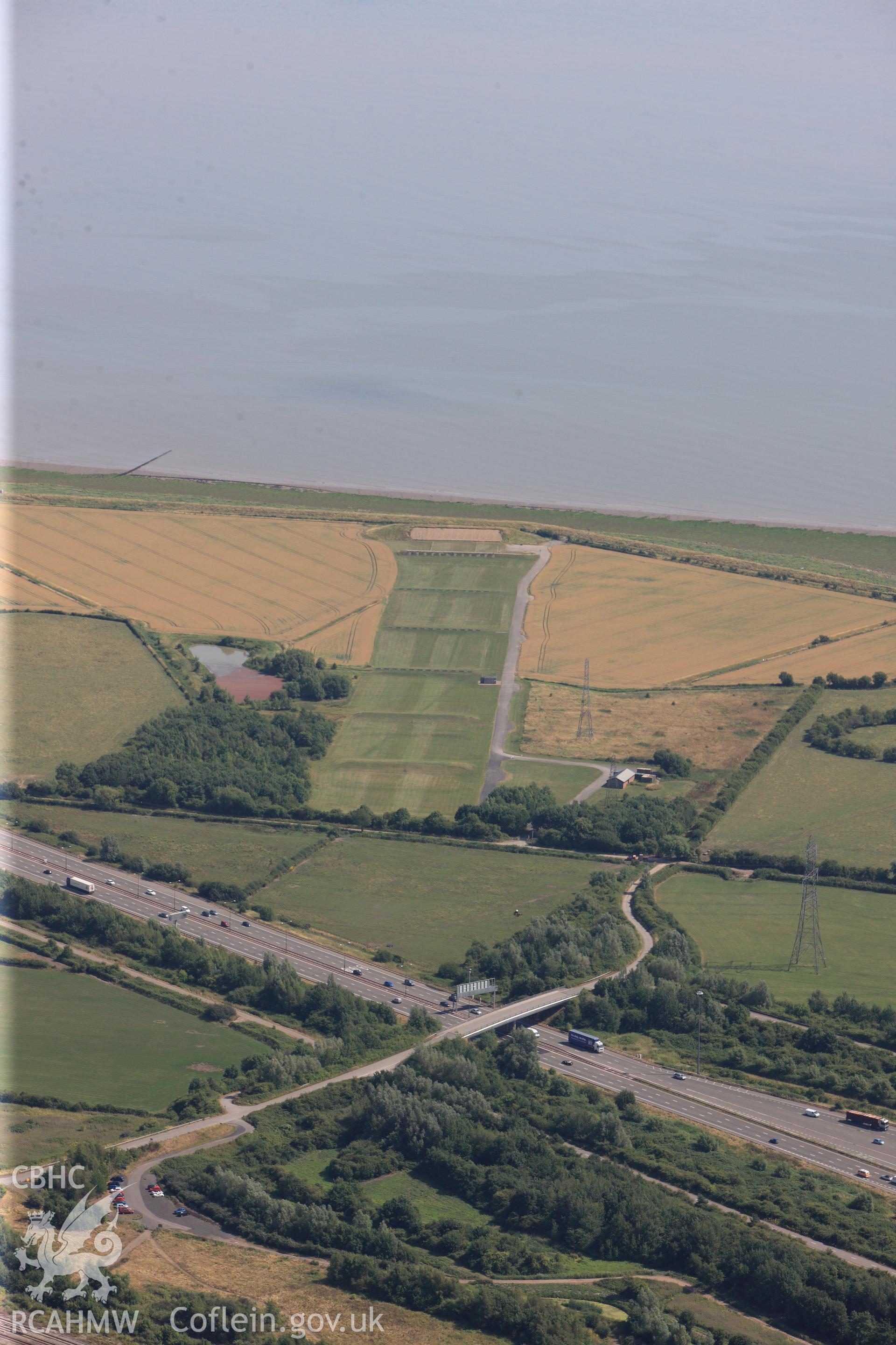 Rogiet Rifle range & section of the M4 motorway running along southern edge of Caldicot, on its way to the Second Severn Crossing. Oblique aerial photograph taken during RCAHMW?s programme of archaeological aerial reconnaissance by Toby Driver, 1 Aug 2013.