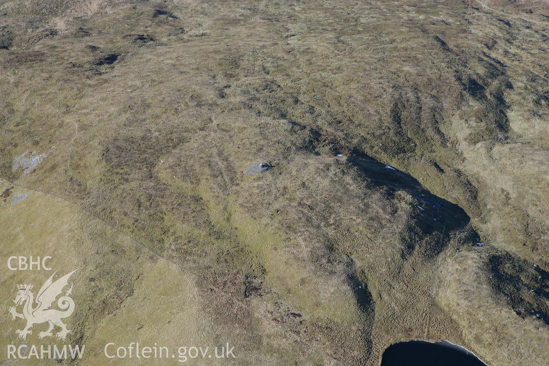 RCAHMW colour oblique photograph of Llechwedd Llwyd cairn. Taken by Toby Driver on 08/03/2010.