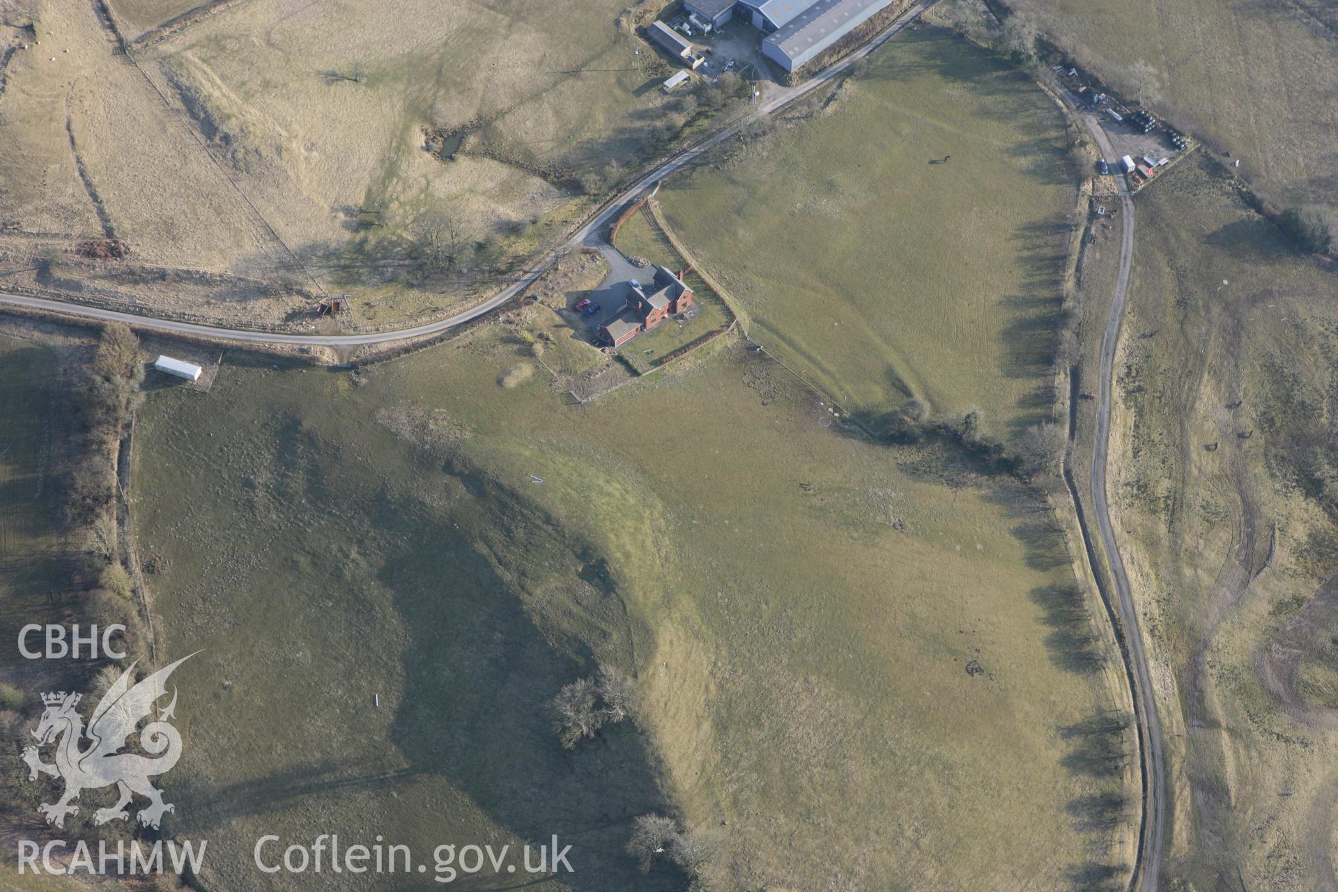 RCAHMW colour oblique photograph of Neuadd, long house. Taken by Toby Driver on 11/03/2010.