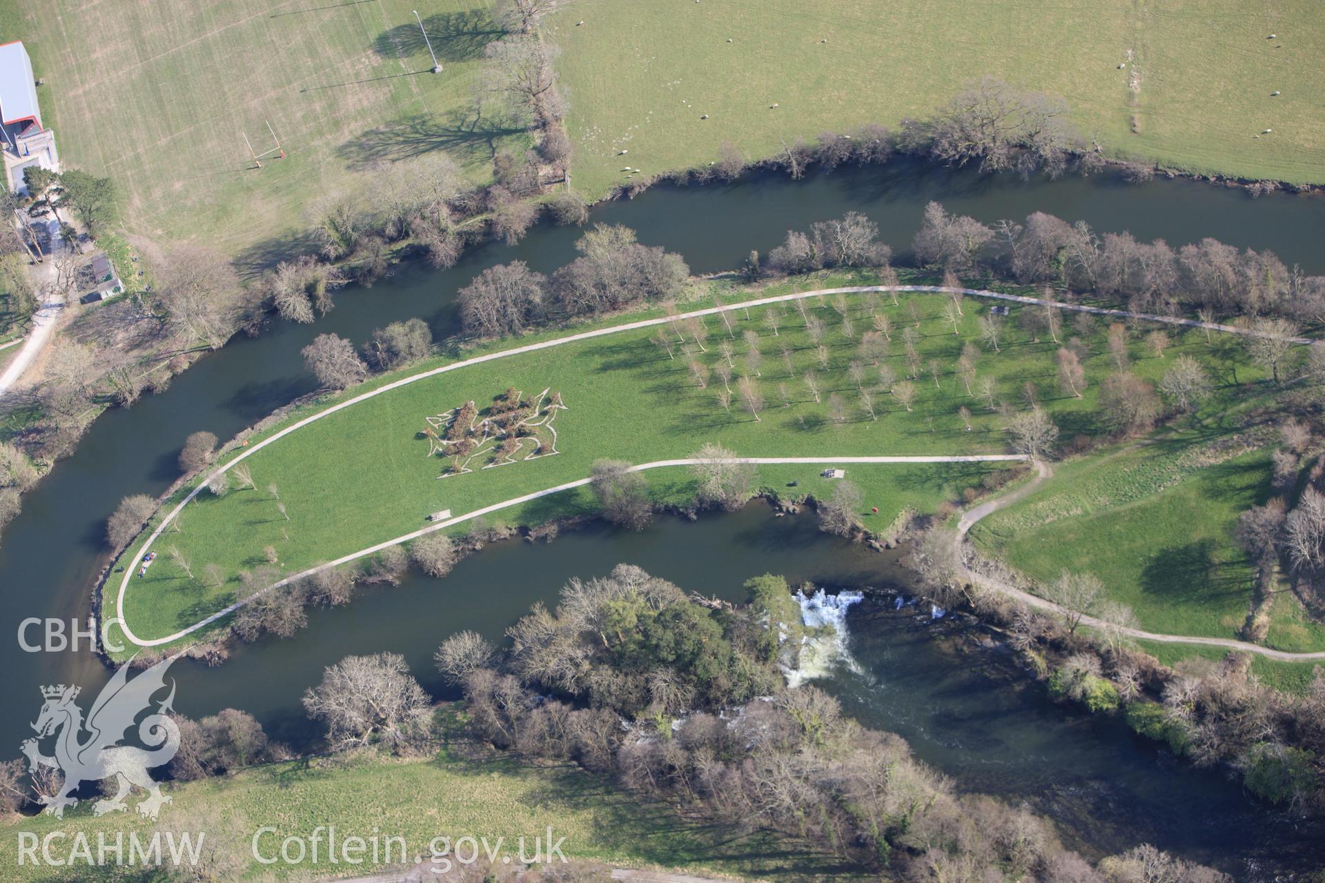 RCAHMW colour oblique aerial photograph of Newcastle Emlyn Castle, showing dragon landscape art on east side of castle. Taken on 13 April 2010 by Toby Driver