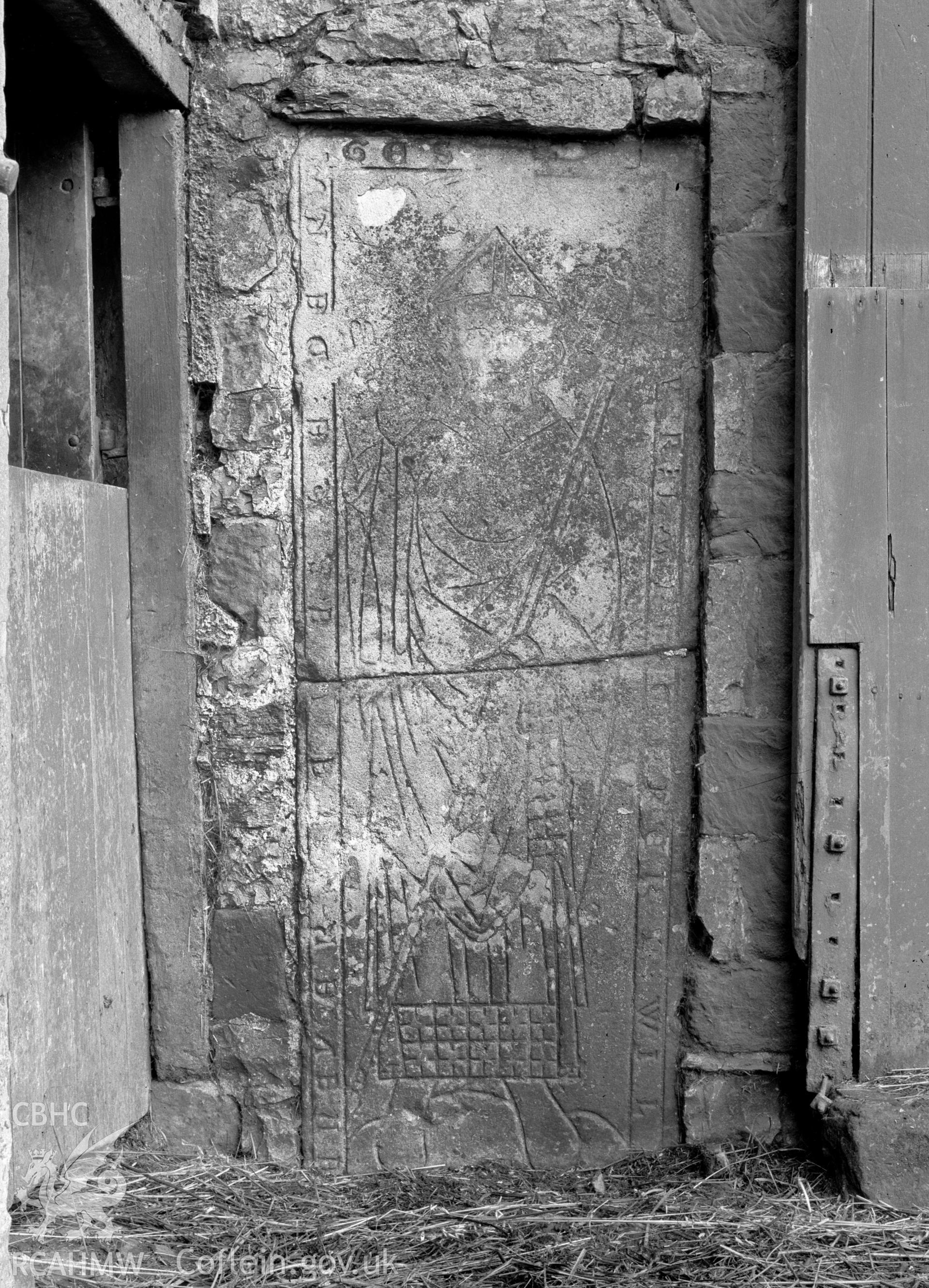 Digital copy of a nitrate negative showing view of inscribed stones in vicarage wall at the Friary near Rhuddlan Church, taken by Leonard Monroe.