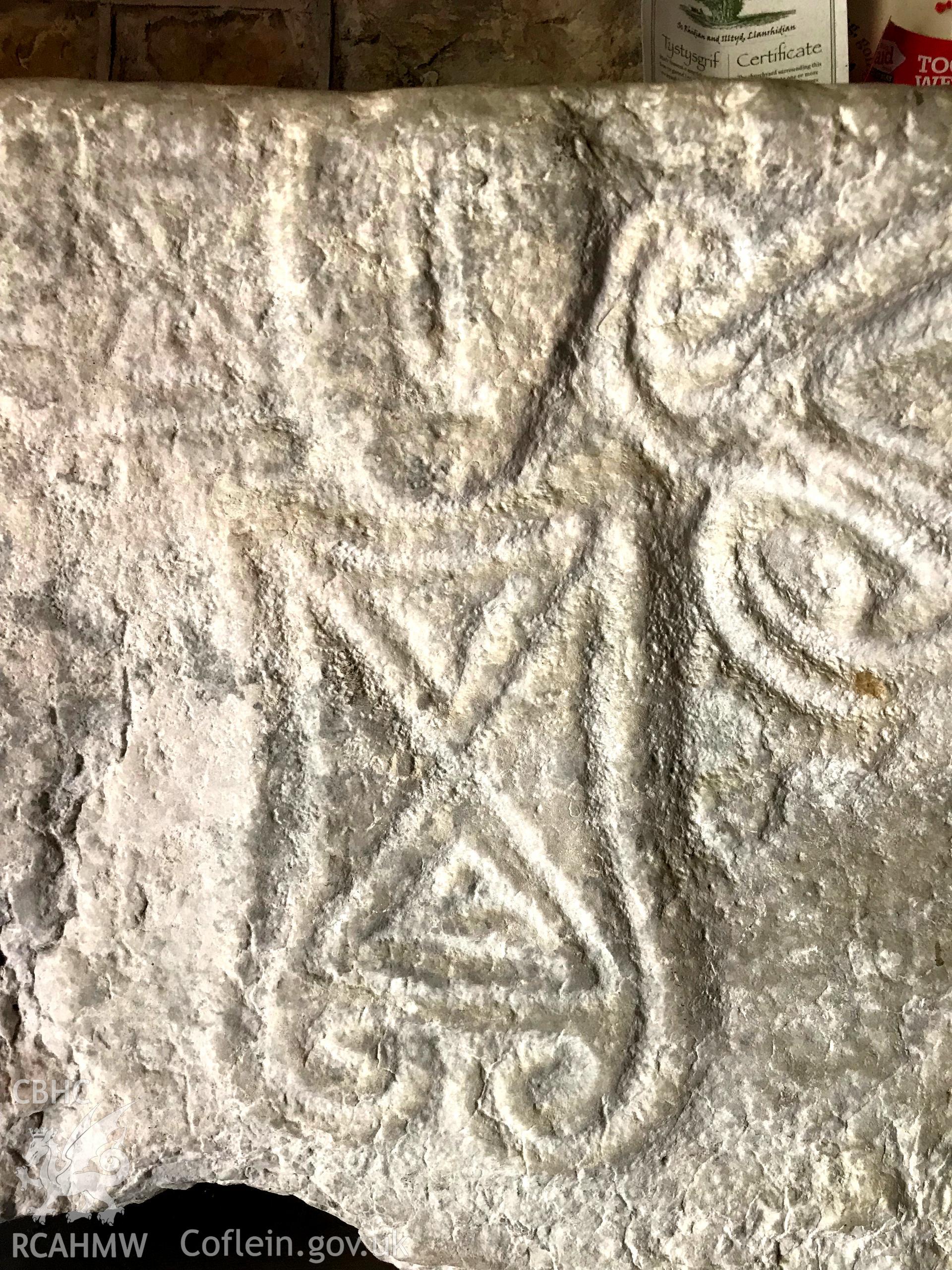 Digital colour photograph showing detailed view of stone relief figure at St Rhidian and Illtyd's church, Llanrhidian, taken by Paul R. Davis on 5th May 2019.