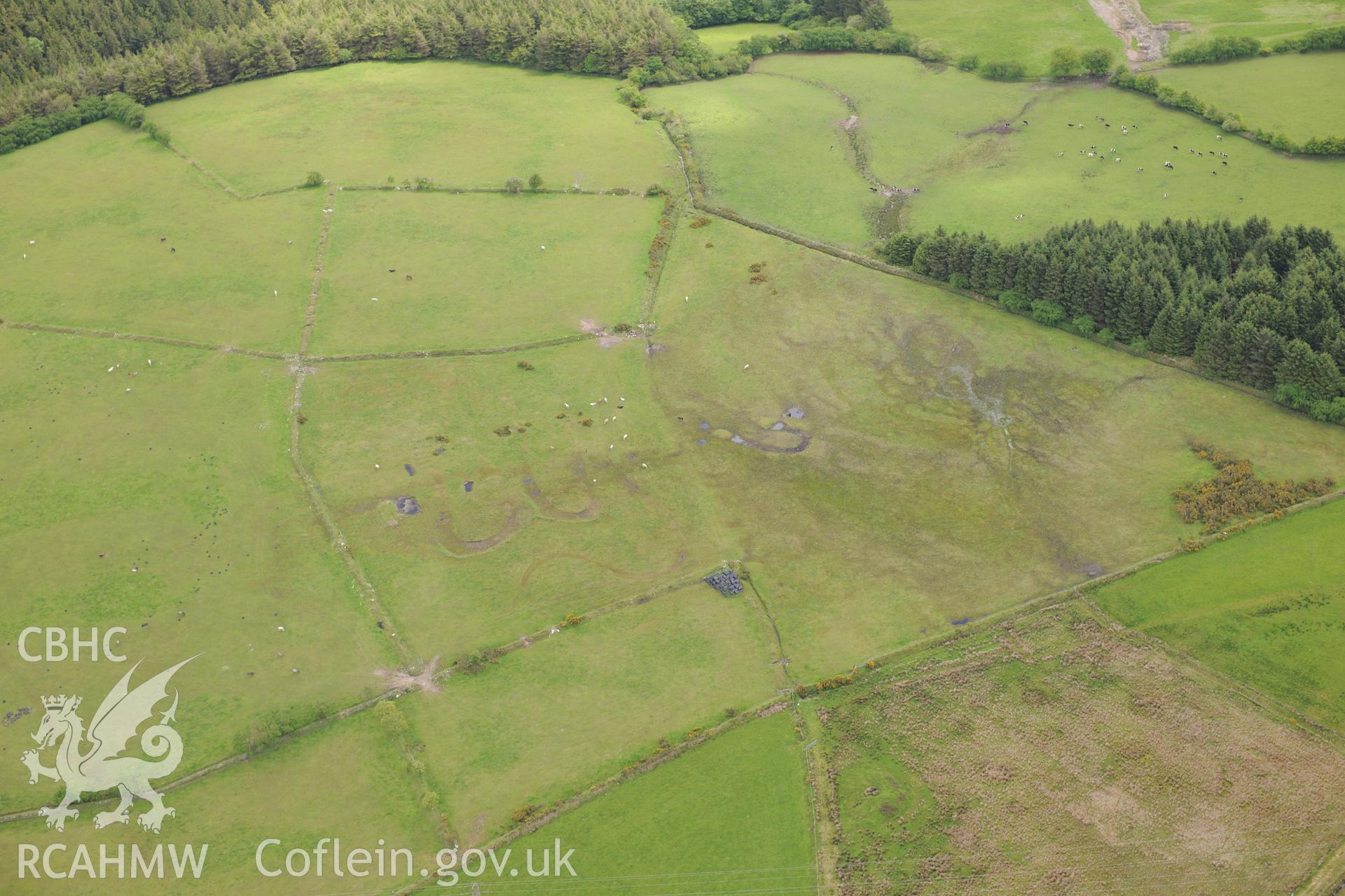 Cructarw round barrow, Llangeler. Oblique aerial photograph taken during the Royal Commission's programme of archaeological aerial reconnaissance by Toby Driver on 3rd June 2015.