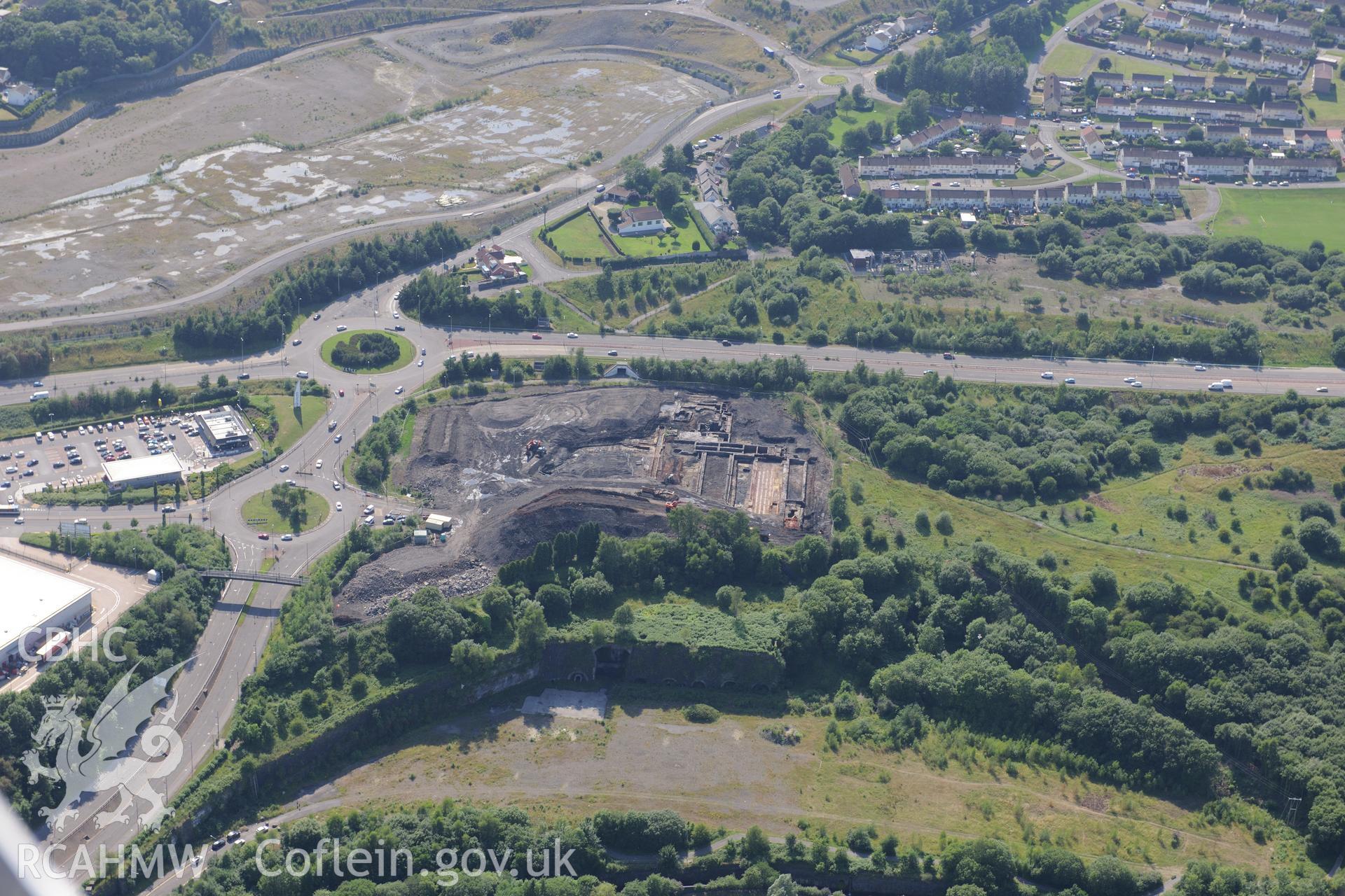 Site of former Rotax factory, Cyfarthfa Retail Park, and Cyfarthfa Ironworks including the remains of its blast furnaces, under excavation by Glamorgan-Gwent Archaeological Trust. Oblique aerial photograph taken during the Royal Commission?s programme of