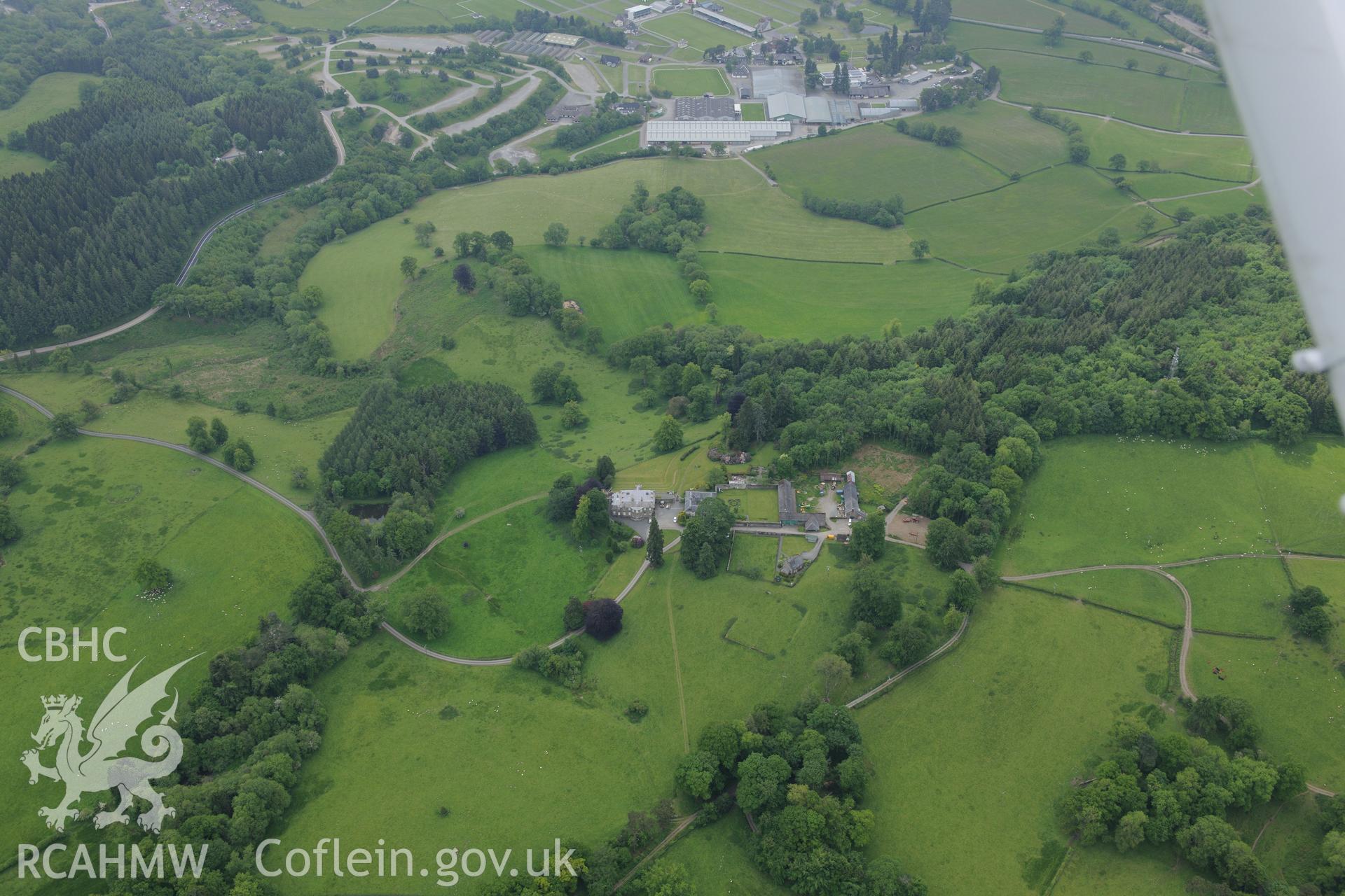 Cefn Dyrys estate including home farm, garden, stables and garden cottage, plus the Royal Welsh Showground, near Builth Wells. Oblique aerial photograph taken during the Royal Commission's programme of archaeological aerial reconnaissance by Toby Driver on 11th June 2015.