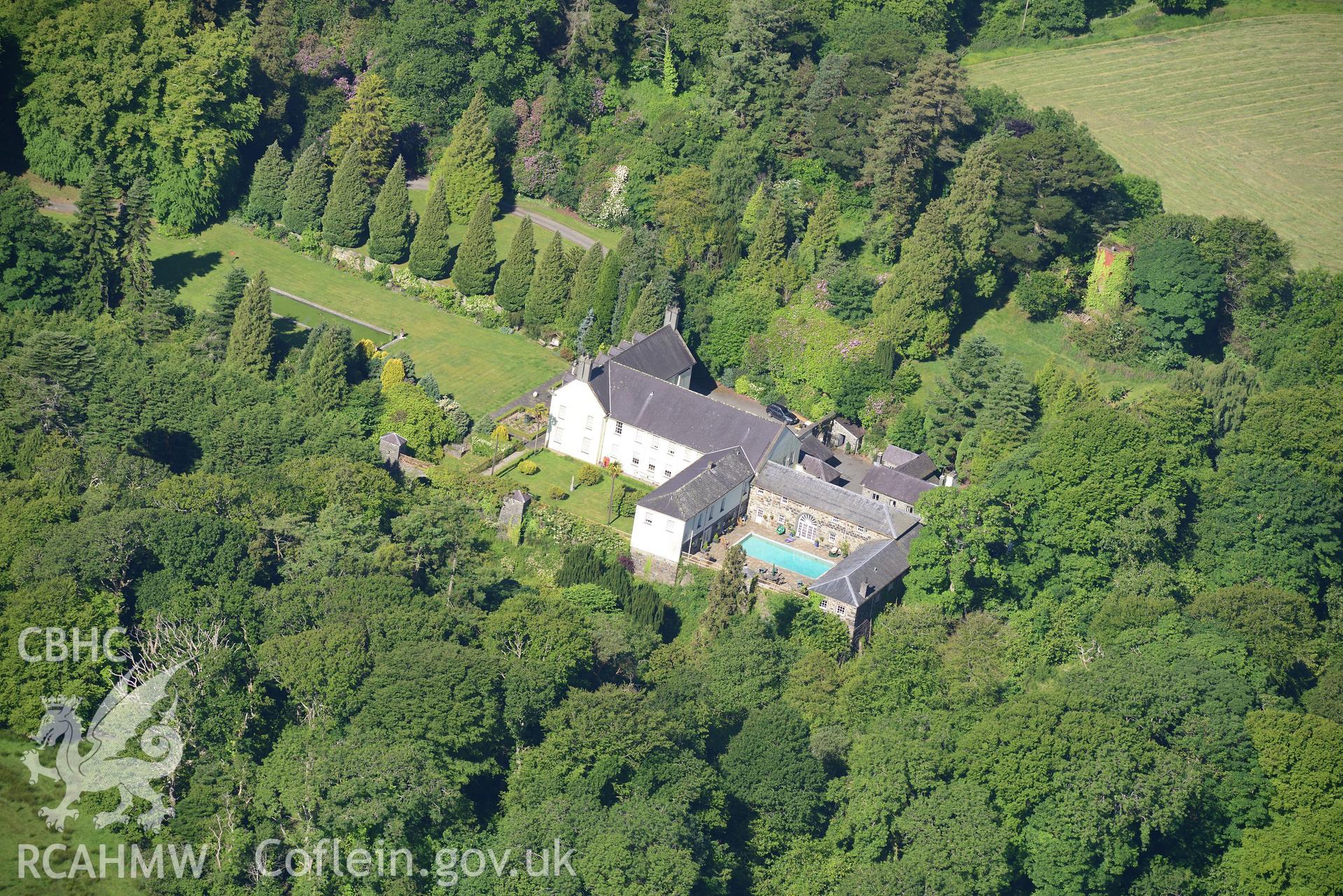 Plas Boduan surrounded by its park and gardens. Oblique aerial photograph taken during the Royal Commission's programme of archaeological aerial reconnaissance by Toby Driver on 23rd June 2015.