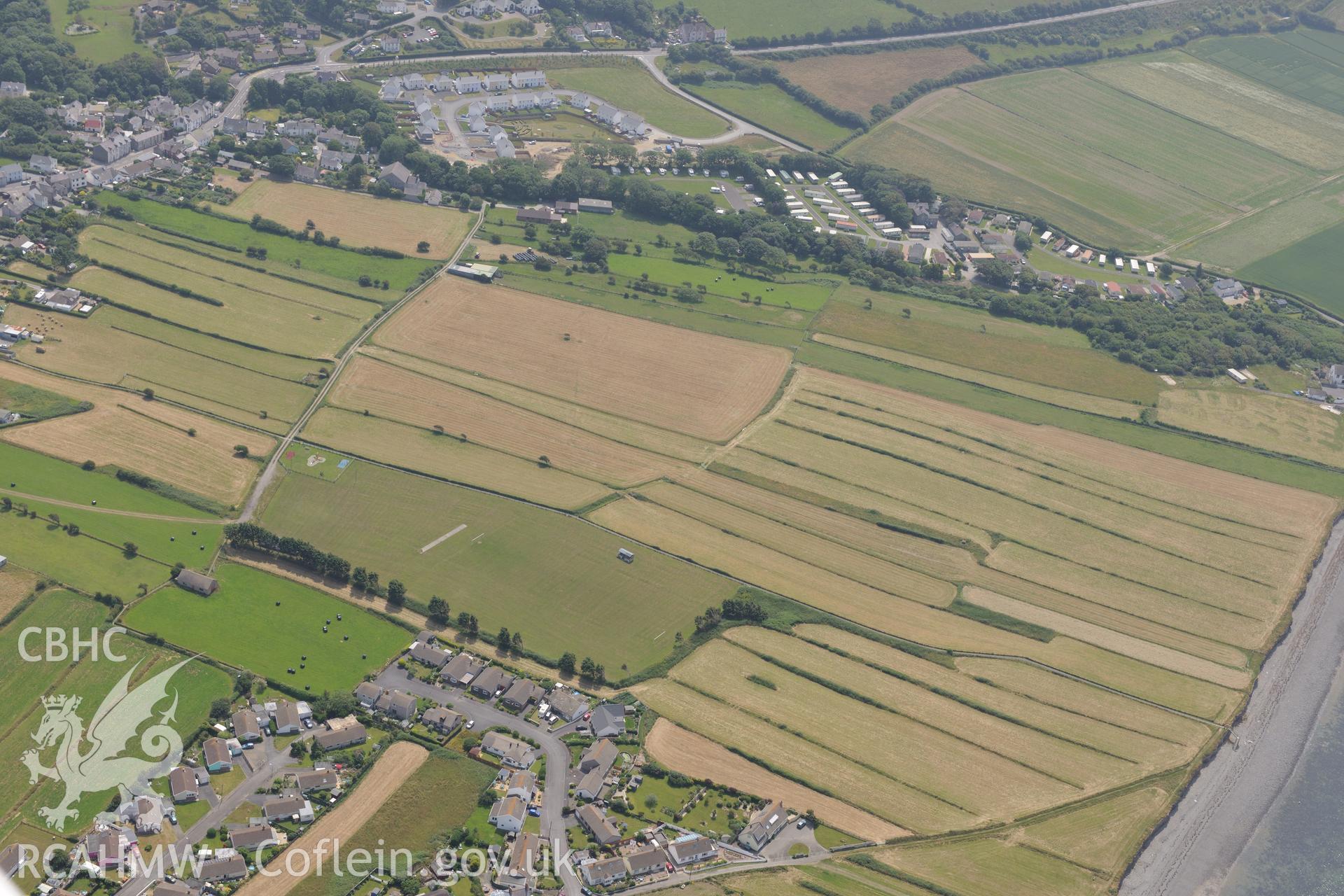 The village of Llanon, Ceredigion, including view of Llanon field system and site of Llansantffraid priory and nunnery. Oblique aerial photograph taken during the Royal Commission?s programme of archaeological aerial reconnaissance by Toby Driver on 12th