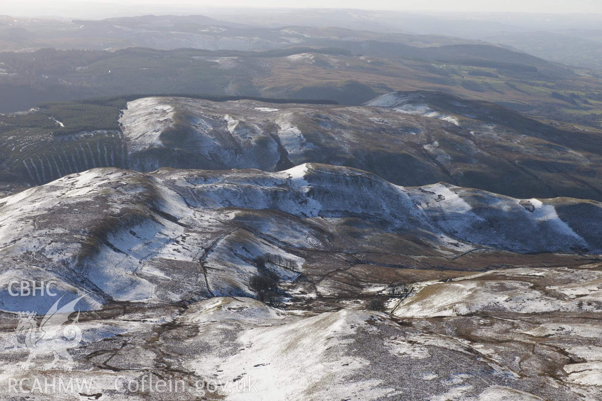 Long view of Castell Rhyfel hillfort from the north. Oblique aerial photograph taken during the Royal Commission's programme of archaeological aerial reconnaissance by Toby Driver on 4th February 2015.