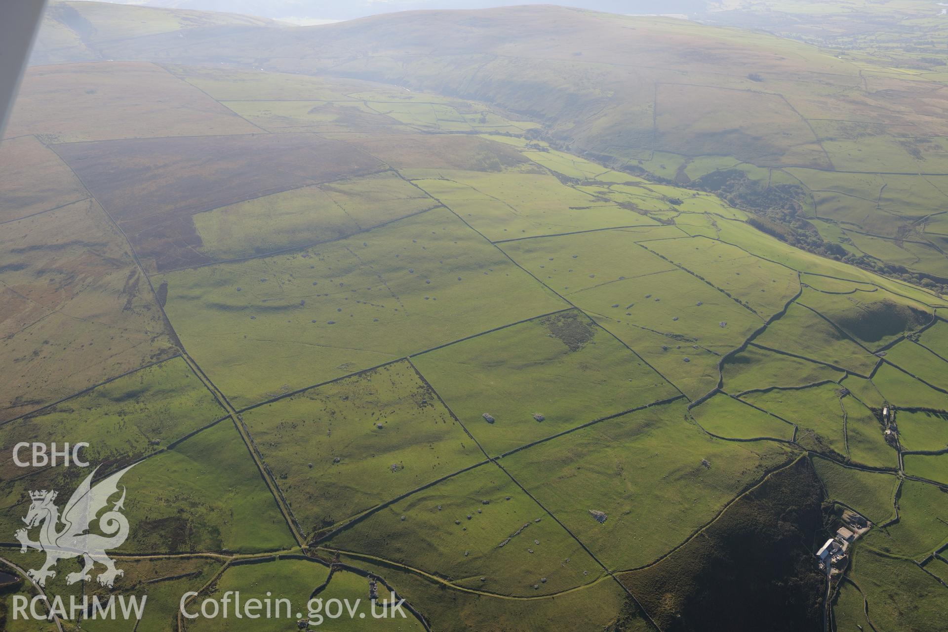 View from the west of Parth-y-Gwddwch homestead and Gwastadgoed cairns and standing stones, near Llwyngwril. Oblique aerial photograph taken during the Royal Commission's programme of archaeological aerial reconnaissance by Toby Driver on 2nd October 2015.