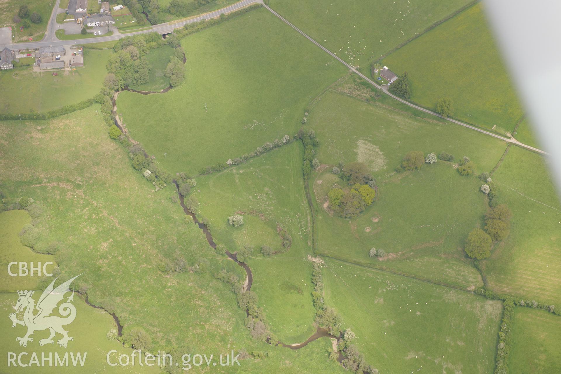 The Mount Motte and Bailey, Hundred House Bridge and Barrow II on Hundred House Common, near Builth Wells. Oblique aerial photograph taken during the Royal Commission's programme of archaeological aerial reconnaissance by Toby Driver on 11th June 2015.