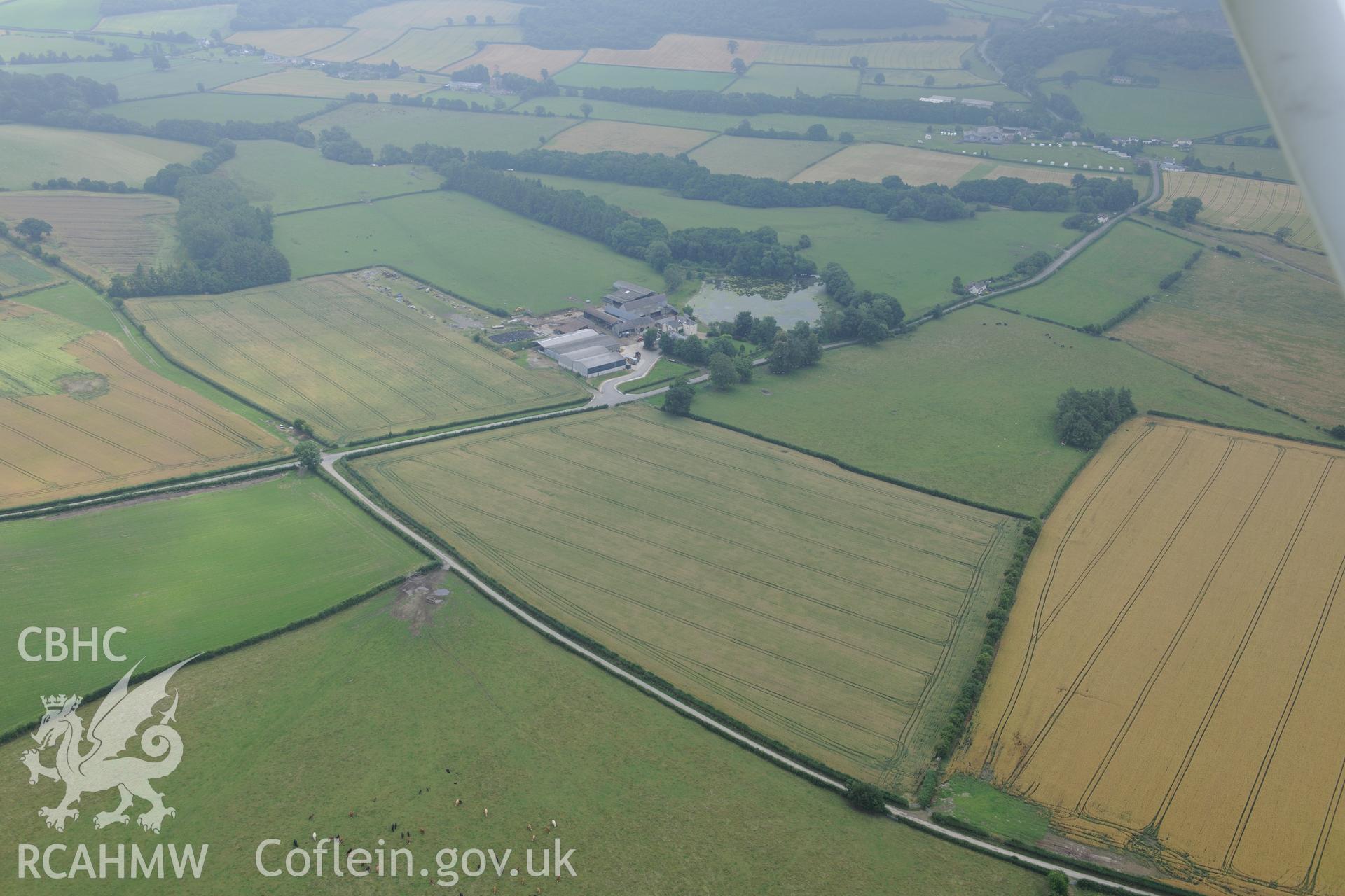 Hindwell Farmstead, Roman fort to the east of farm buildings and Roman camp II to the north, south east of Presteigne. Oblique aerial photograph taken during Royal Commission?s programme of archaeological aerial reconnaissance by Toby Driver, 1st Aug 2013.