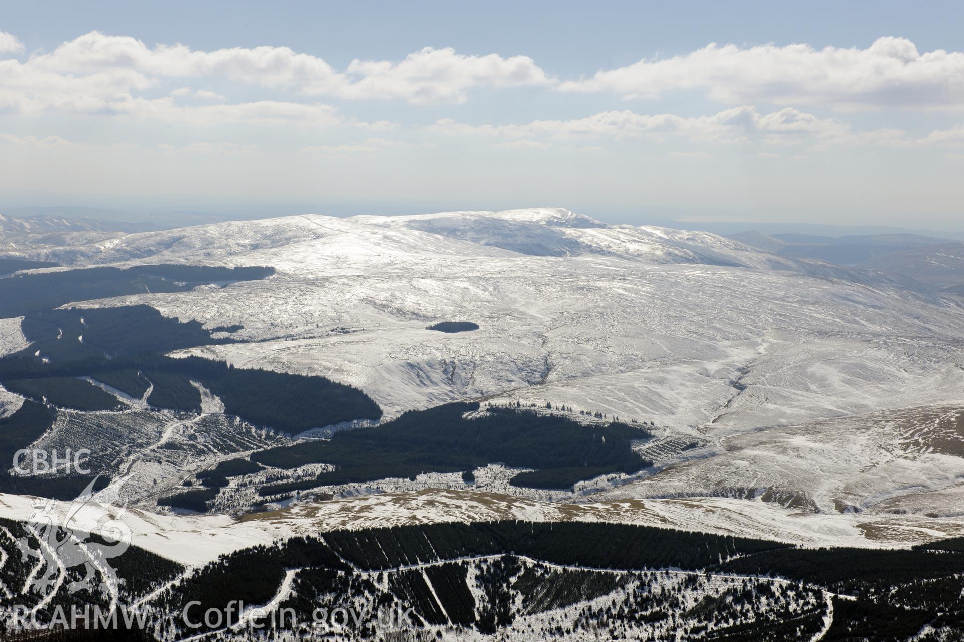 View from the north east of Pumlumon under ice. Oblique aerial photograph taken during the Royal Commission's programme of archaeological aerial reconnaissance by Toby Driver on 2nd April 2013.