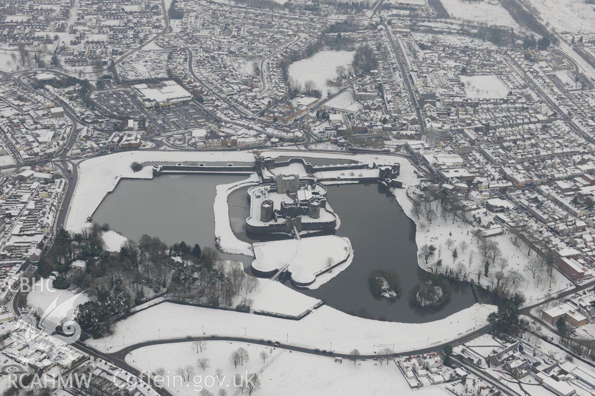 Caerphilly Castle and the town of Caerphilly. Oblique aerial photograph taken during the Royal Commission?s programme of archaeological aerial reconnaissance by Toby Driver on 24th January 2013.