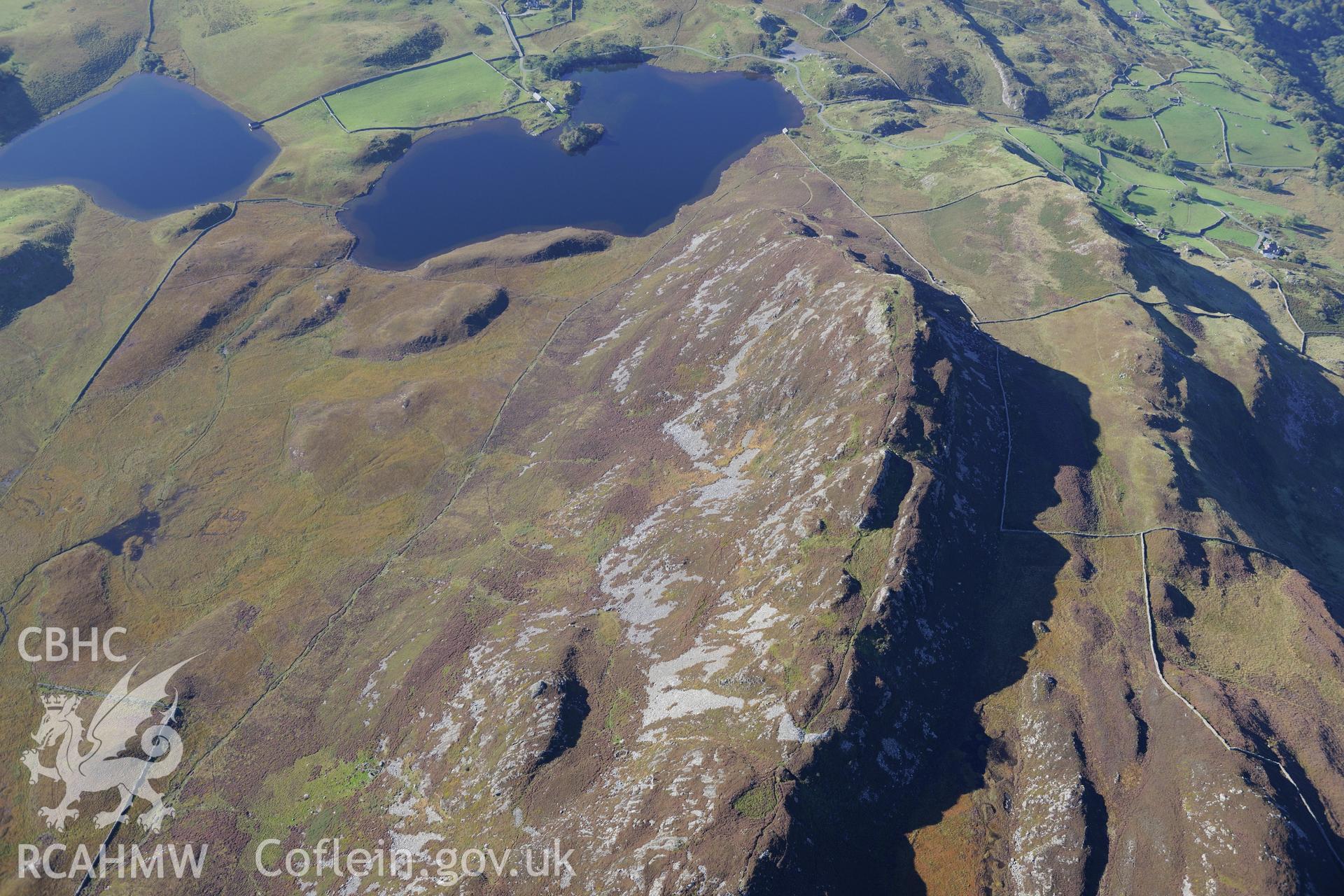 Pared y Cefnhir hillfort and Llynnau Cregennen, about halfway between Dolgellau and Fairbourne. Oblique aerial photograph taken during the Royal Commission's programme of archaeological aerial reconnaissance by Toby Driver on 2nd October 2015.