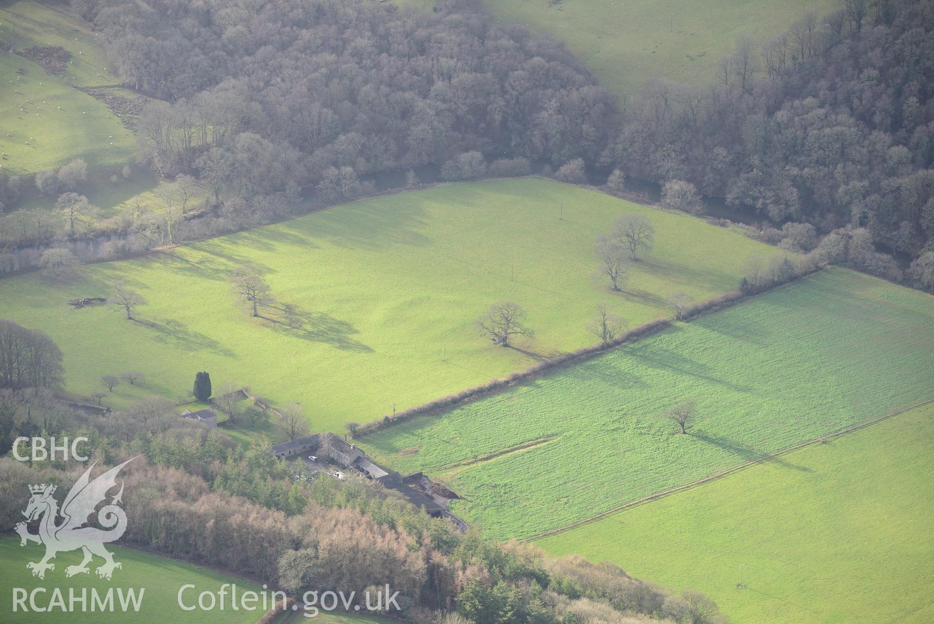 Llanfair House and the defended enclosure at Llanfair Farm. Oblique aerial photograph taken during the Royal Commission's programme of archaeological aerial reconnaissance by Toby Driver on 6th January 2015.