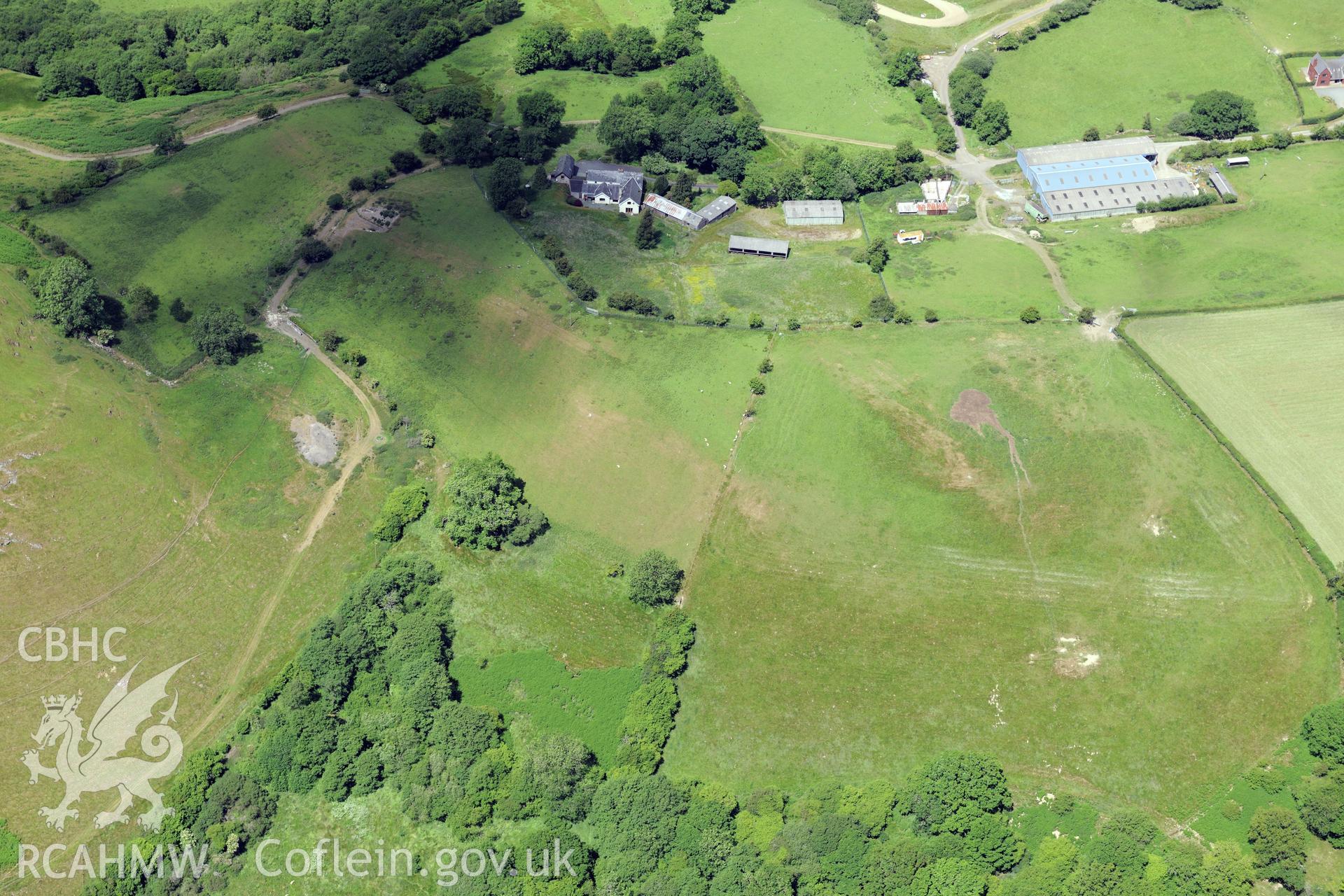 Neuadd and the associated farm, cartshed and stable, east of Llandrindod Wells. Oblique aerial photograph taken during the Royal Commission's programme of archaeological aerial reconnaissance by Toby Driver on 30th June 2015.