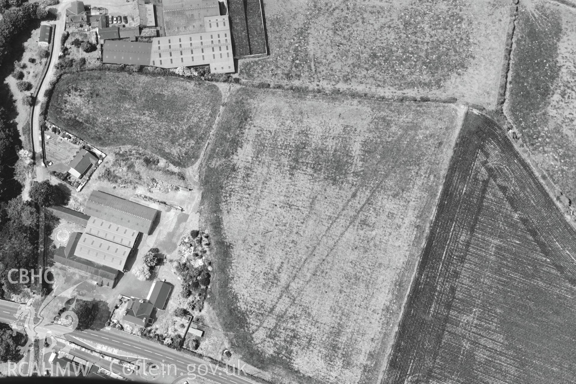 Double ditches at Penlon Farm, Llanon, Aberystwyth. Oblique aerial photograph taken during the Royal Commission?s programme of archaeological aerial reconnaissance by Toby Driver on 12th July 2013.