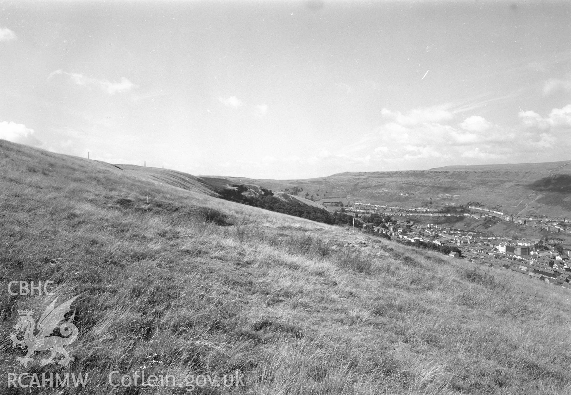 Digital copy of a black and white negative showing view of platform house, medieval earthworks in Ferndale.