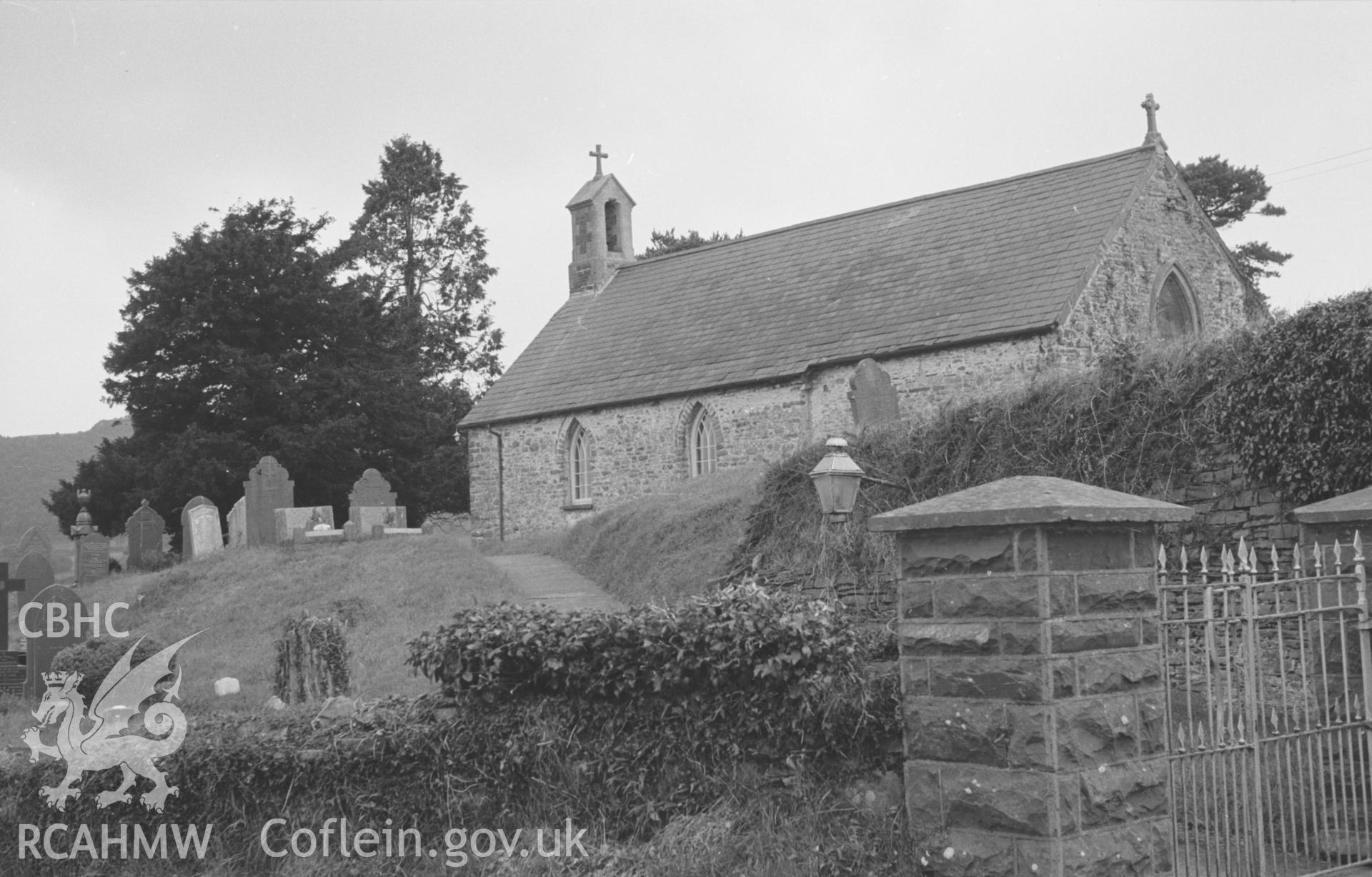 Digital copy of a black and white negative showing exterior view of St. Cybi's church, Llangybi (Ceredigion). Photographed by Arthur O. Chater in August 1965 from the main road at Grid Reference SN 6089 5316, looking west north west.