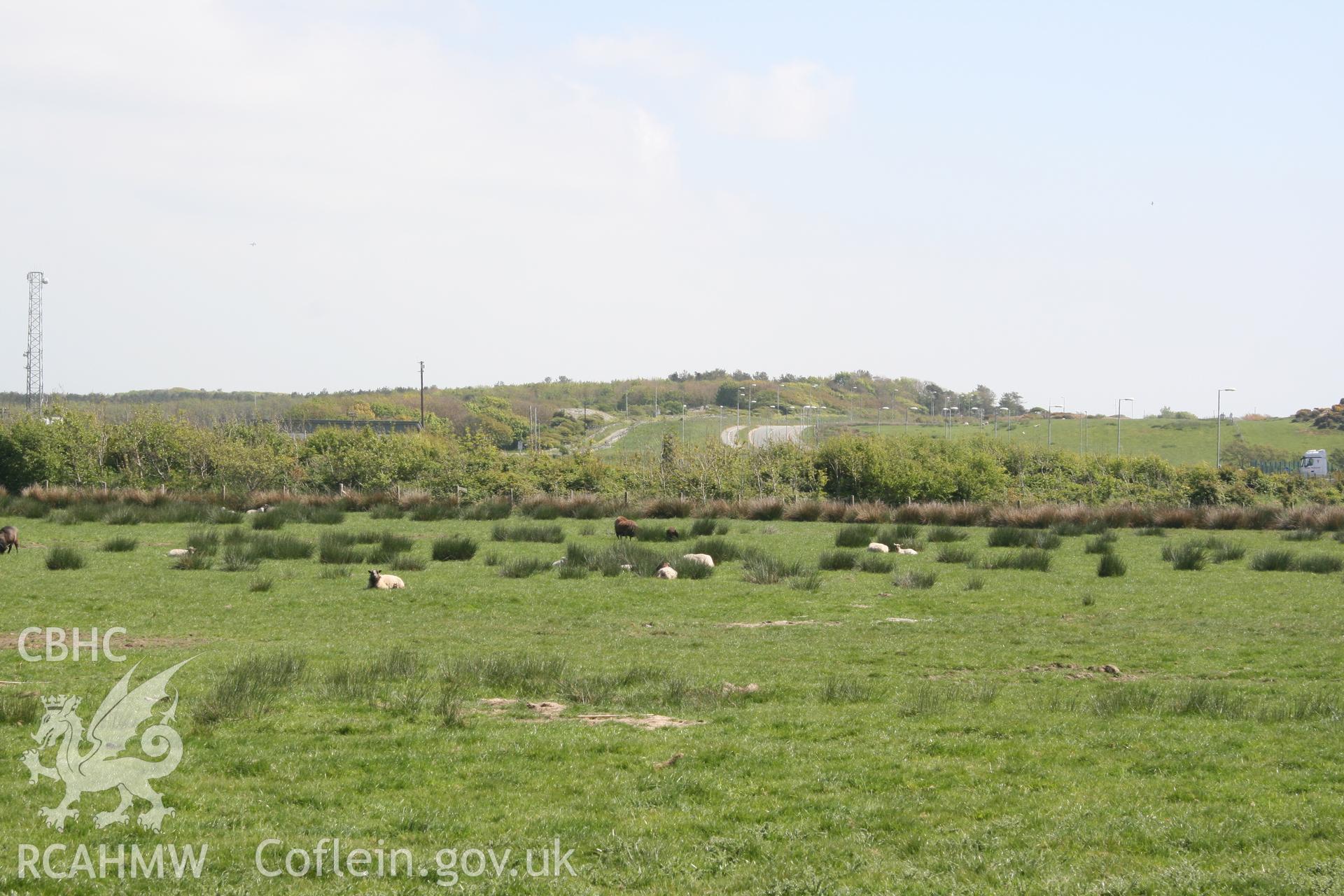 View from development site towards Trefignath Chambered Tomb. Looking southeast. Digital photograph taken as part of archaeological work at Parc Cybi Enterprise Zone, Holyhead, Anglesey, carried out by Archaeology Wales, 2017. Project number: P2522.