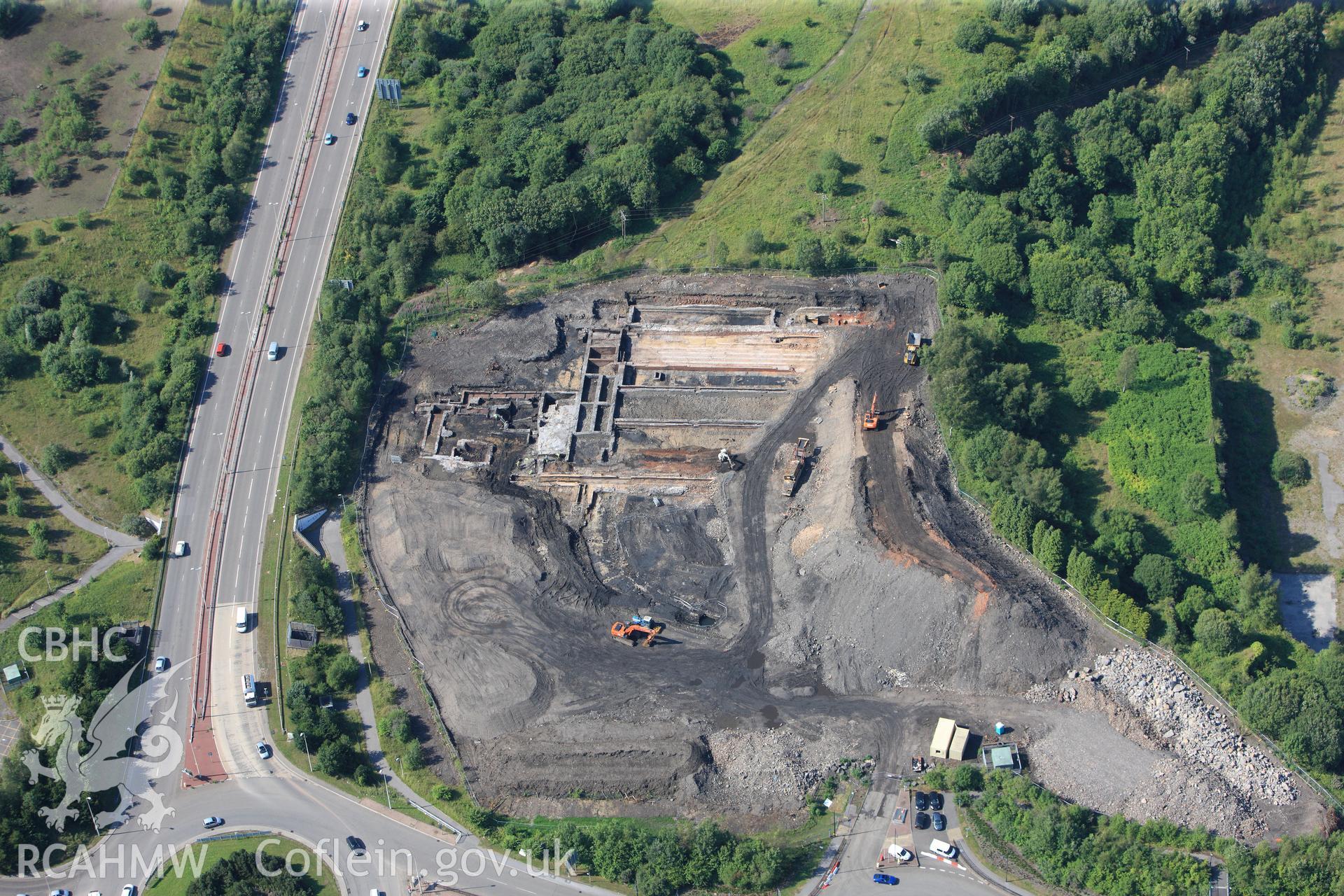 Site of former Rotax factory, and Cyfarthfa Ironworks including the remains of its blast furnaces, under excavation by Glamorgan-Gwent Archaeological Trust. Oblique aerial photograph taken during the Royal Commission?s programme of archaeological aerial reconnaissance by Toby Driver on 1st August 2013.