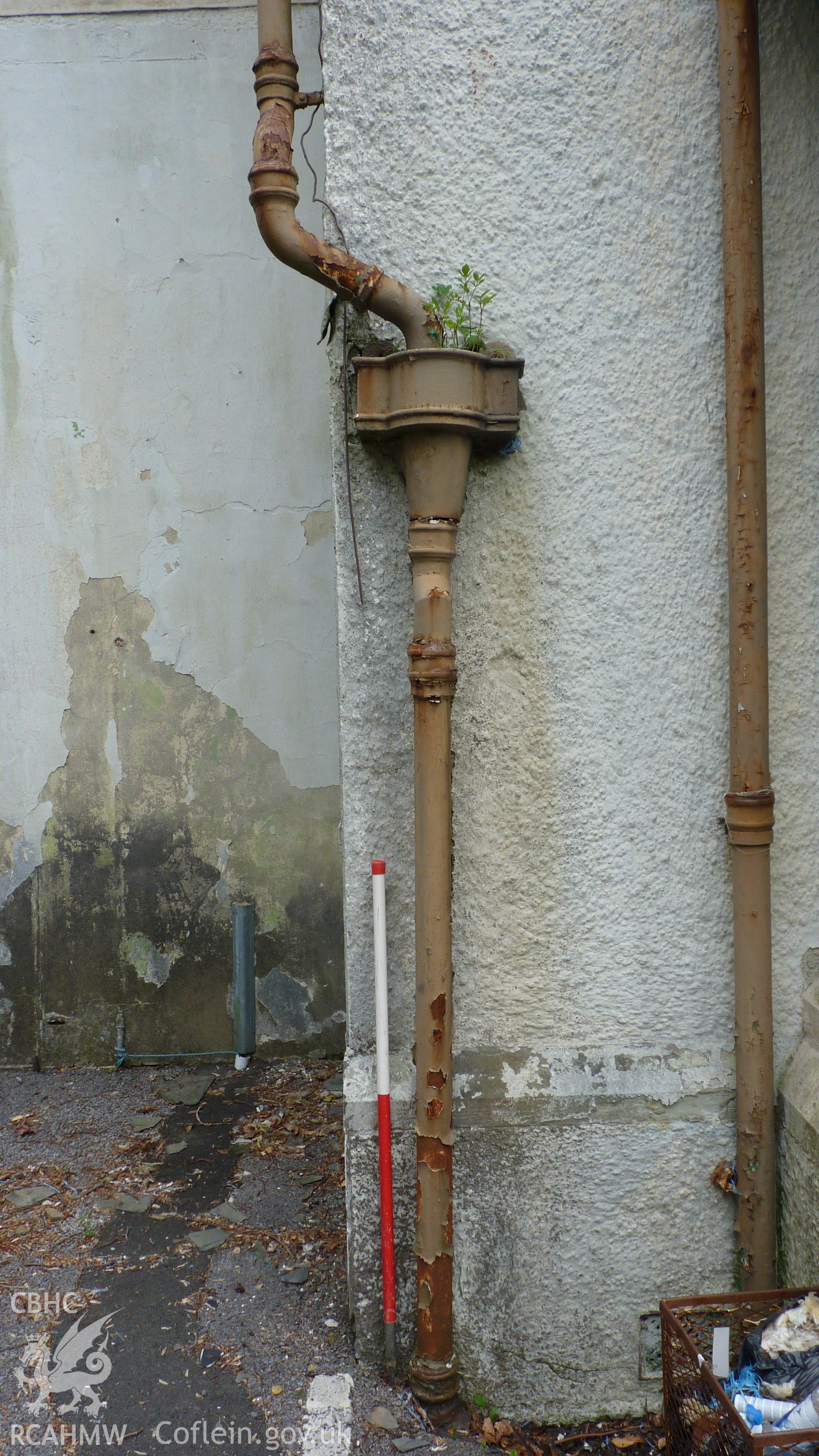 'Detail of cast iron drain pipes on Coed Parc. 1m scale.' Photographed as part of archaeological work at Coed Parc, Newcastle, Bridgend, carried out by Archaeology Wales, 2016. Project no. P2432.