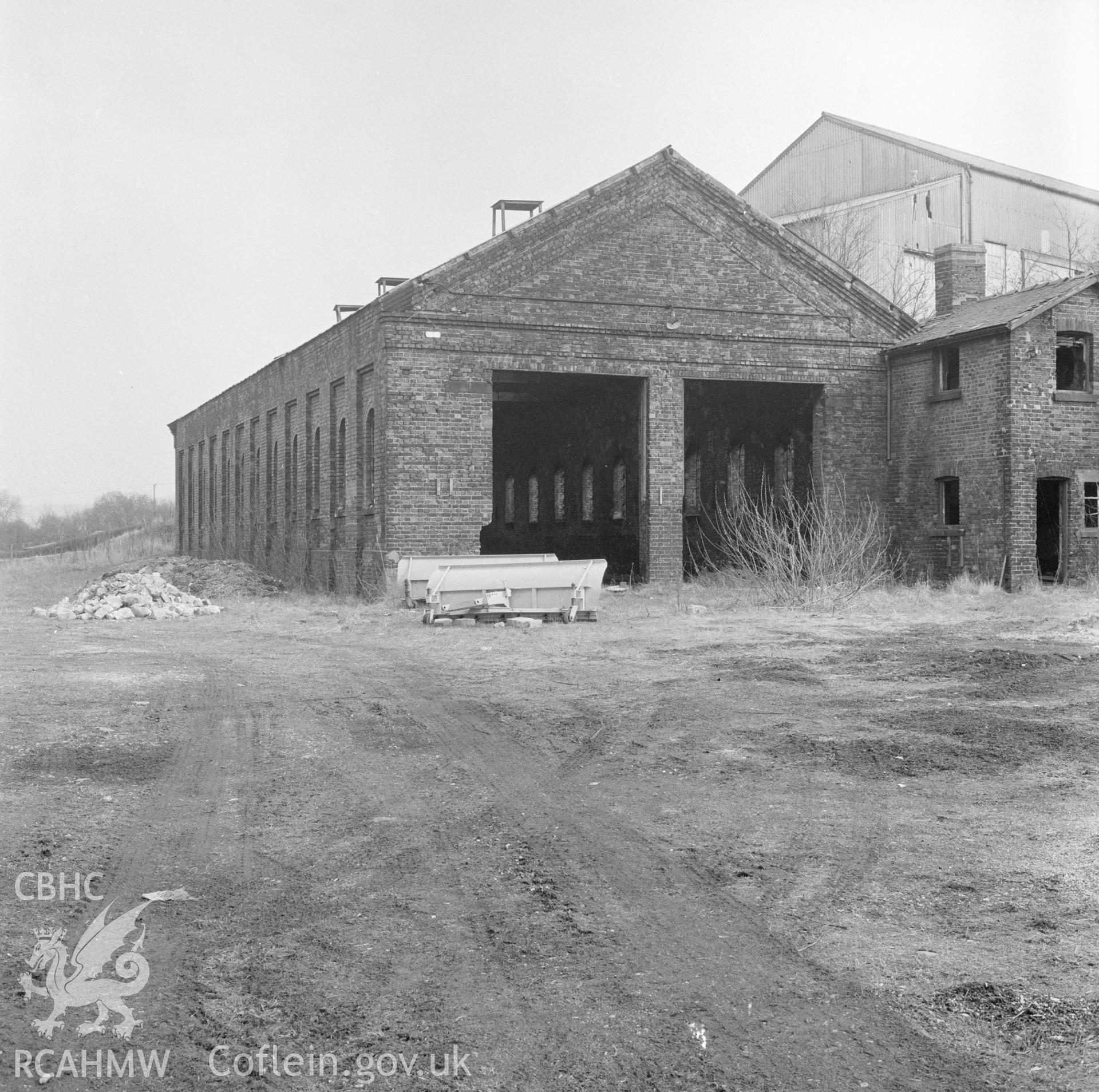 Digital copy of a black and white negative showing a view of the the train storage building at Llanidloes Railway Station taken by Douglas Hague.