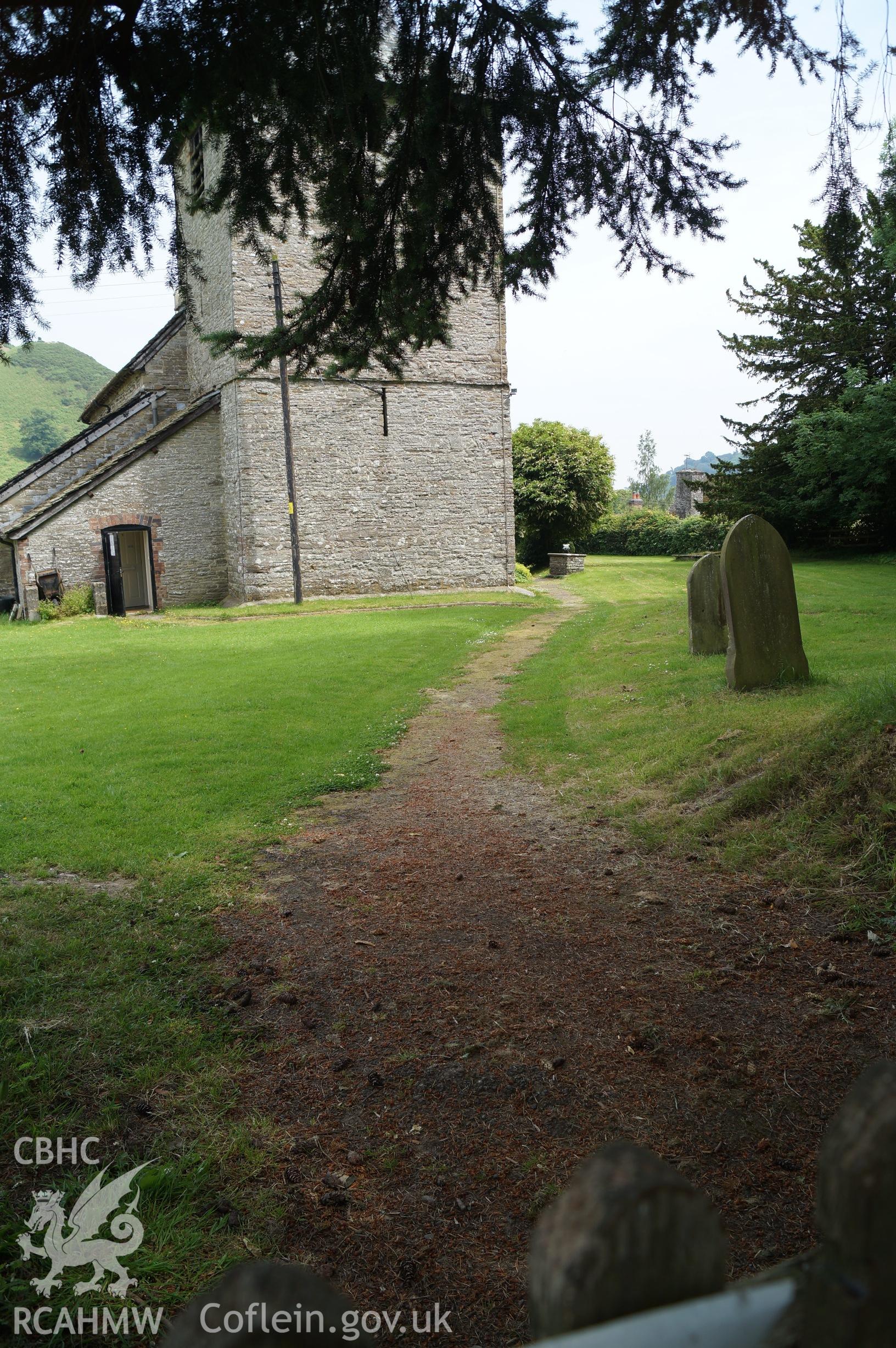 View 'looking east southeast at the western pathway to be widened from the gateway to the west of St. Mary's church' in Gladestry, Powys. Photograph and description by Jenny Hall and Paul Sambrook of Trysor, 21st June 2017.