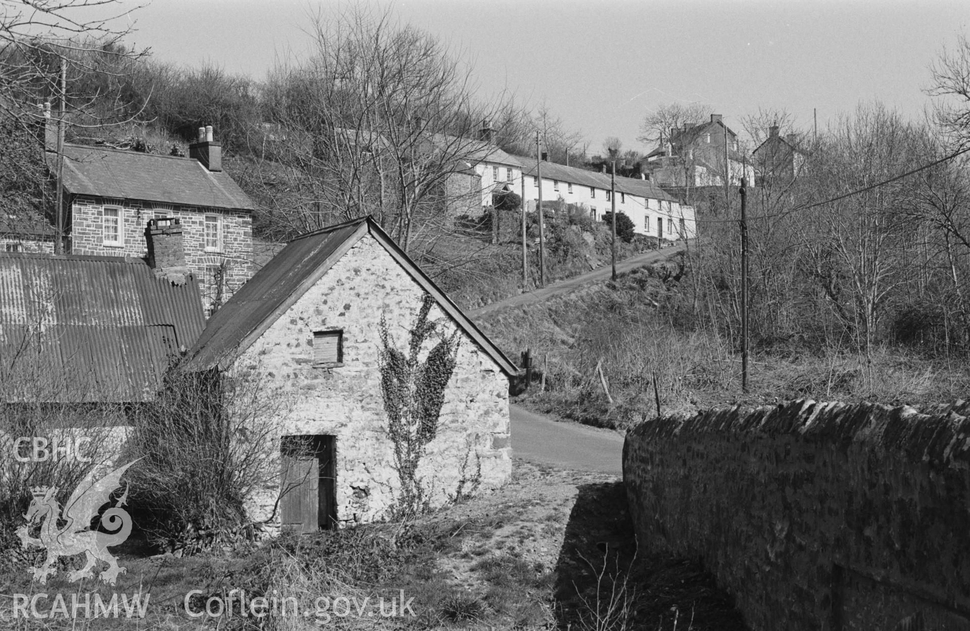 Digital copy of a black and white negative showing Penbontrhydyfoethau village, south west of New Quay. Photographed by Arthur O. Chater in April 1968. (Looking east from the bridge, Grid Reference SN 358 547).