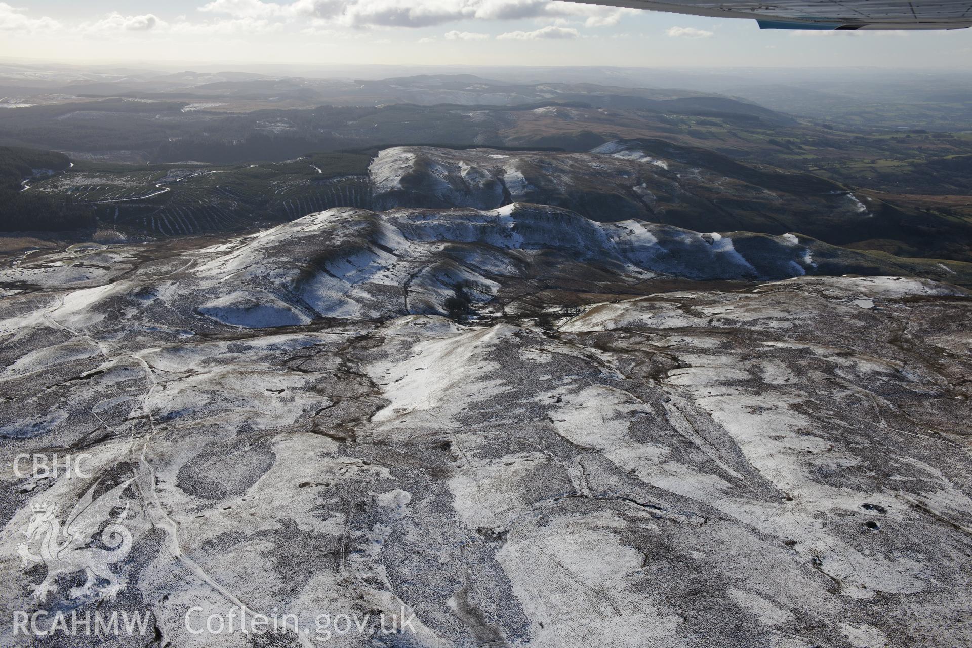 Long view of Castell Rhyfel hillfort from the north. Oblique aerial photograph taken during the Royal Commission's programme of archaeological aerial reconnaissance by Toby Driver on 4th February 2015.