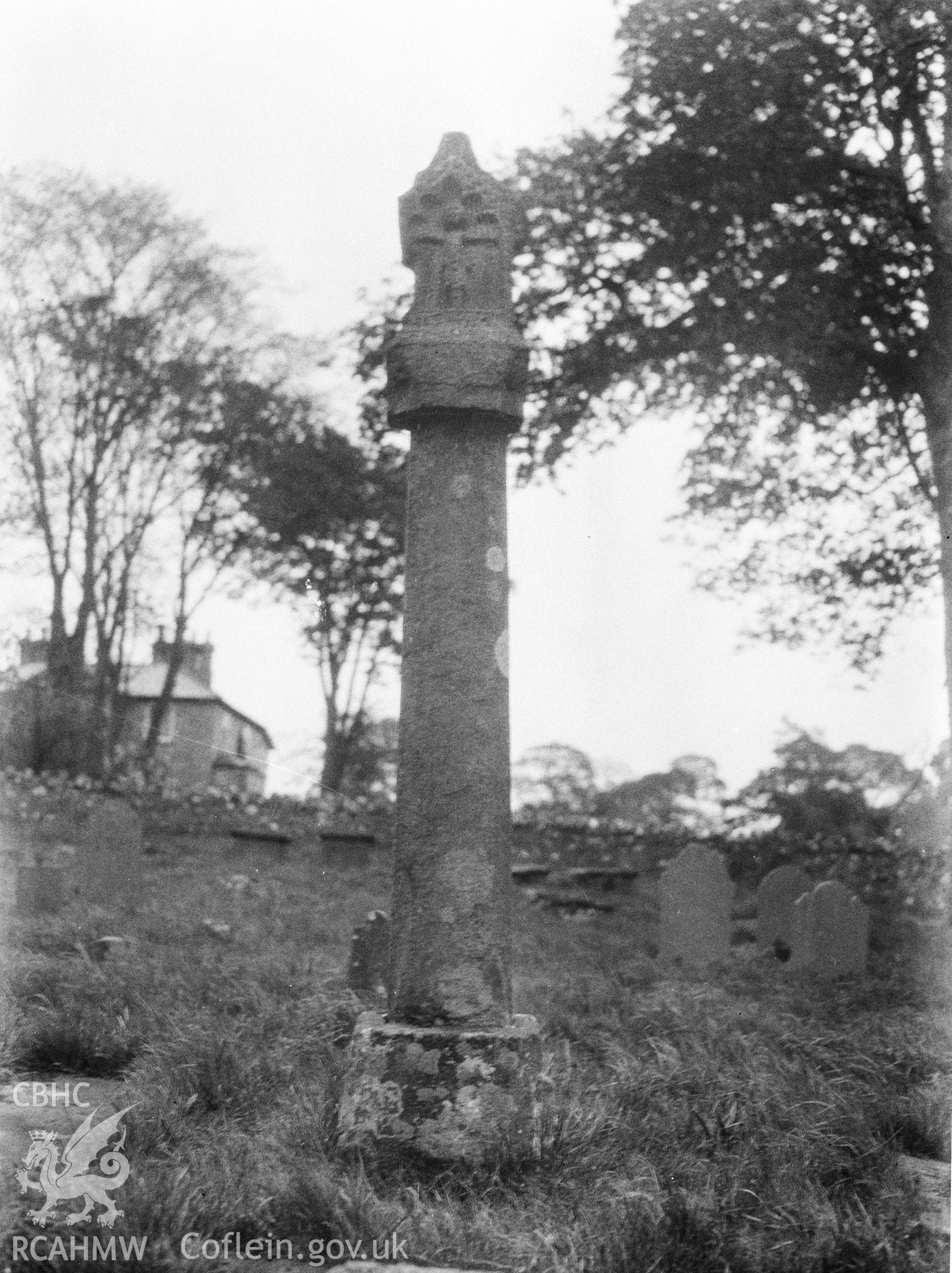 Digital copy of a nitrate negative showing exterior view of Trelawnyd churchyard cross. From the National Building Record Postcard Collection.