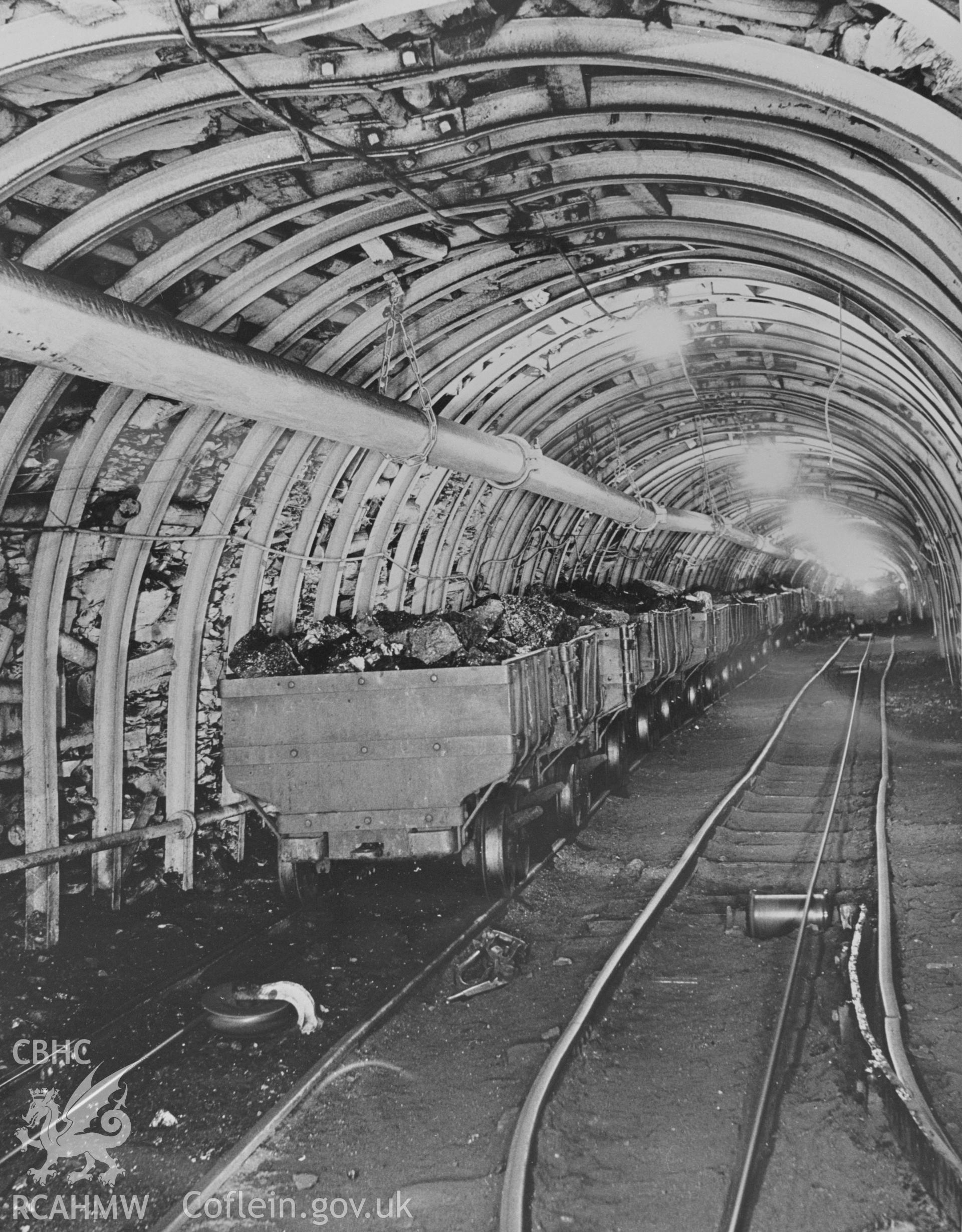 Digital copy of an acetate negative showing coal trams underground at Cefn Coed Colliery, from the John Cornwell Collection.