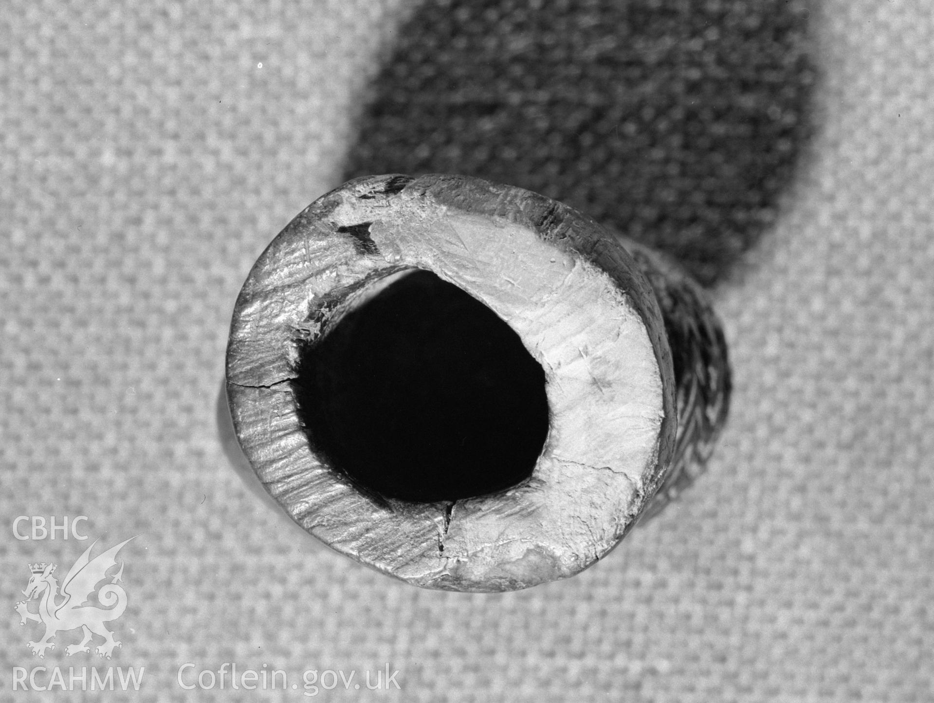 Digital copy of a black and white negative showing carved wooden head from Llanio Roman Fort.