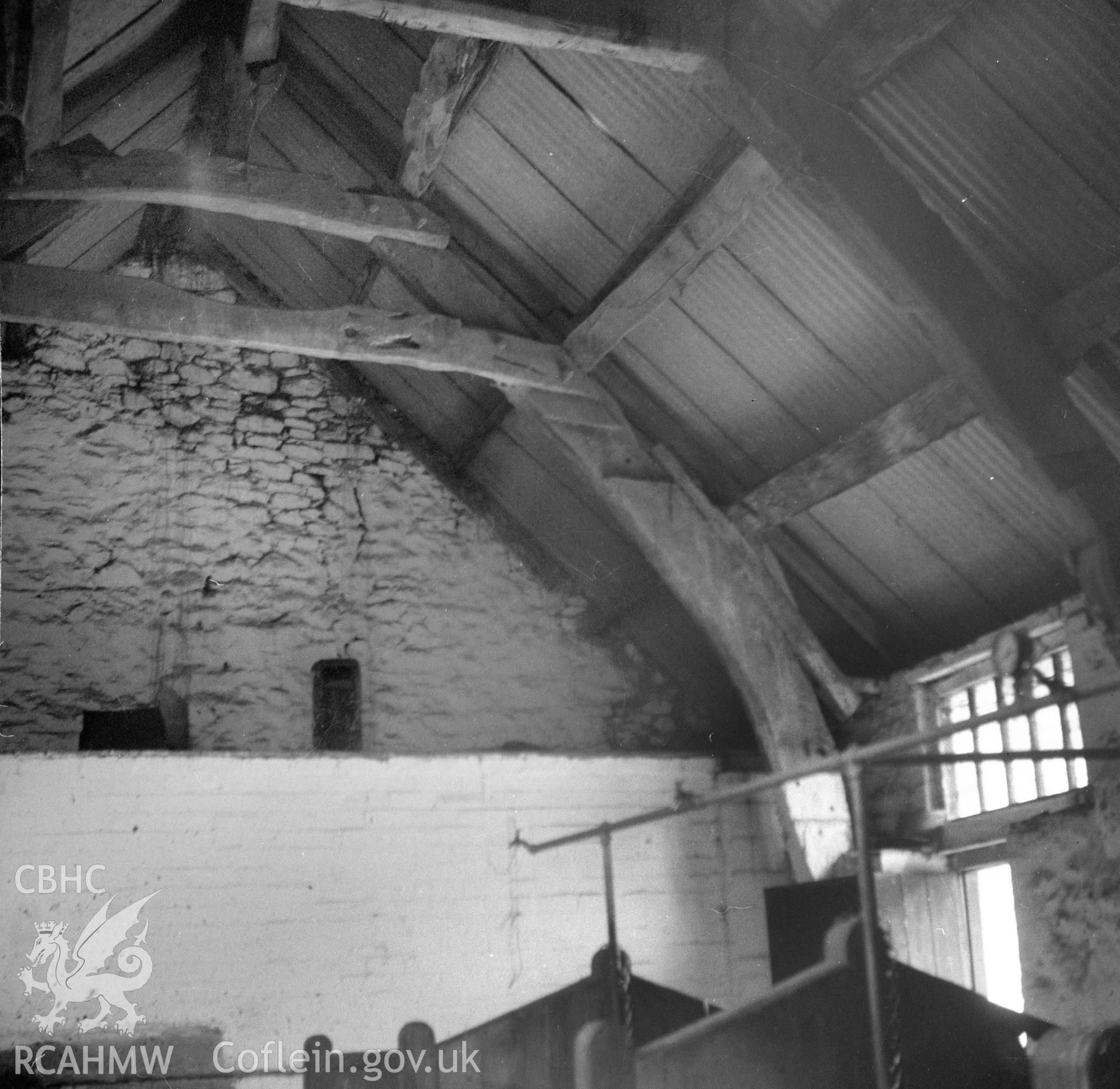 Digital copy of a nitrate negative showing interior view of the cruck barn at Maes y Rhiw, Llansadwrn.